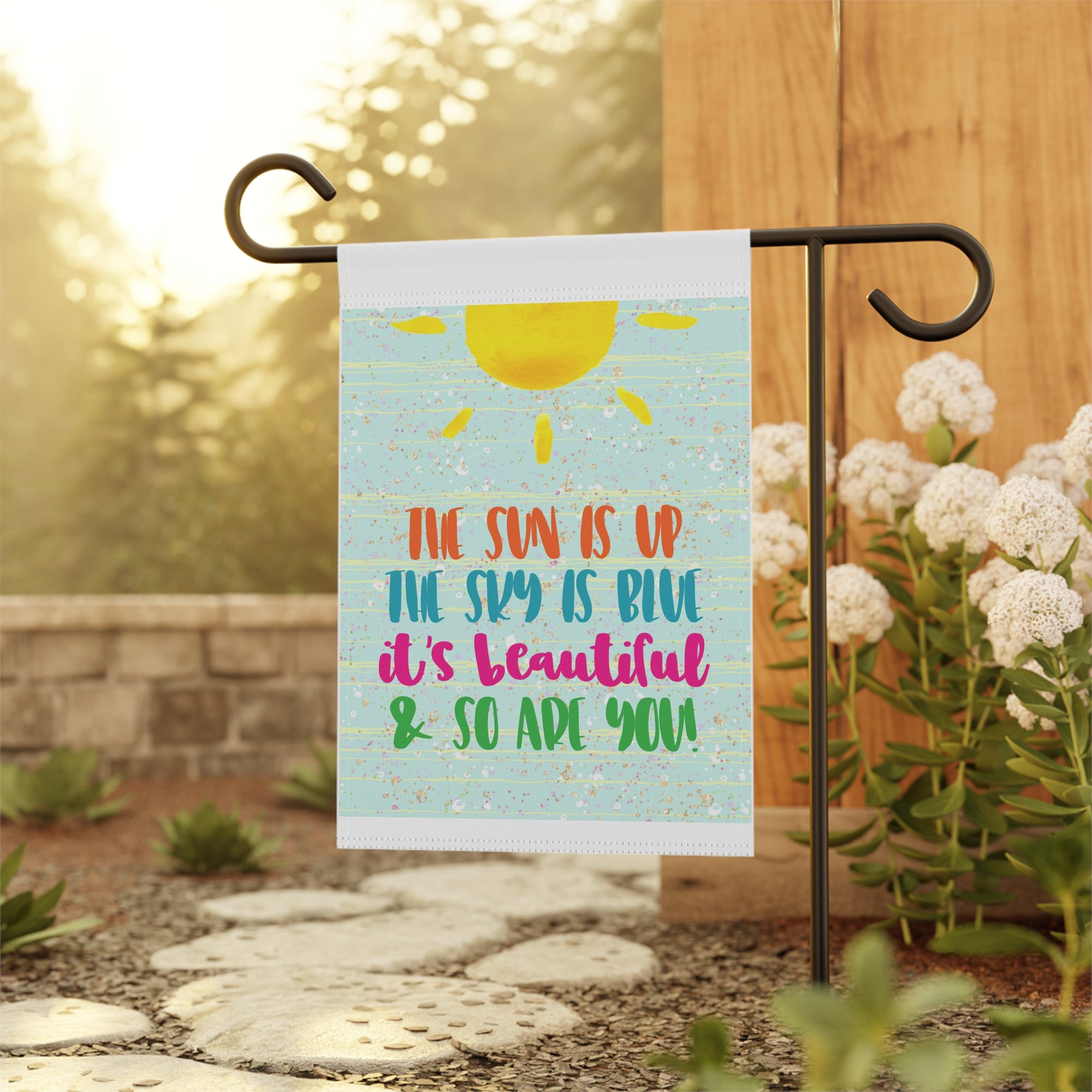 Inspirational sunshine garden flag displayed outdoors on a happy porch