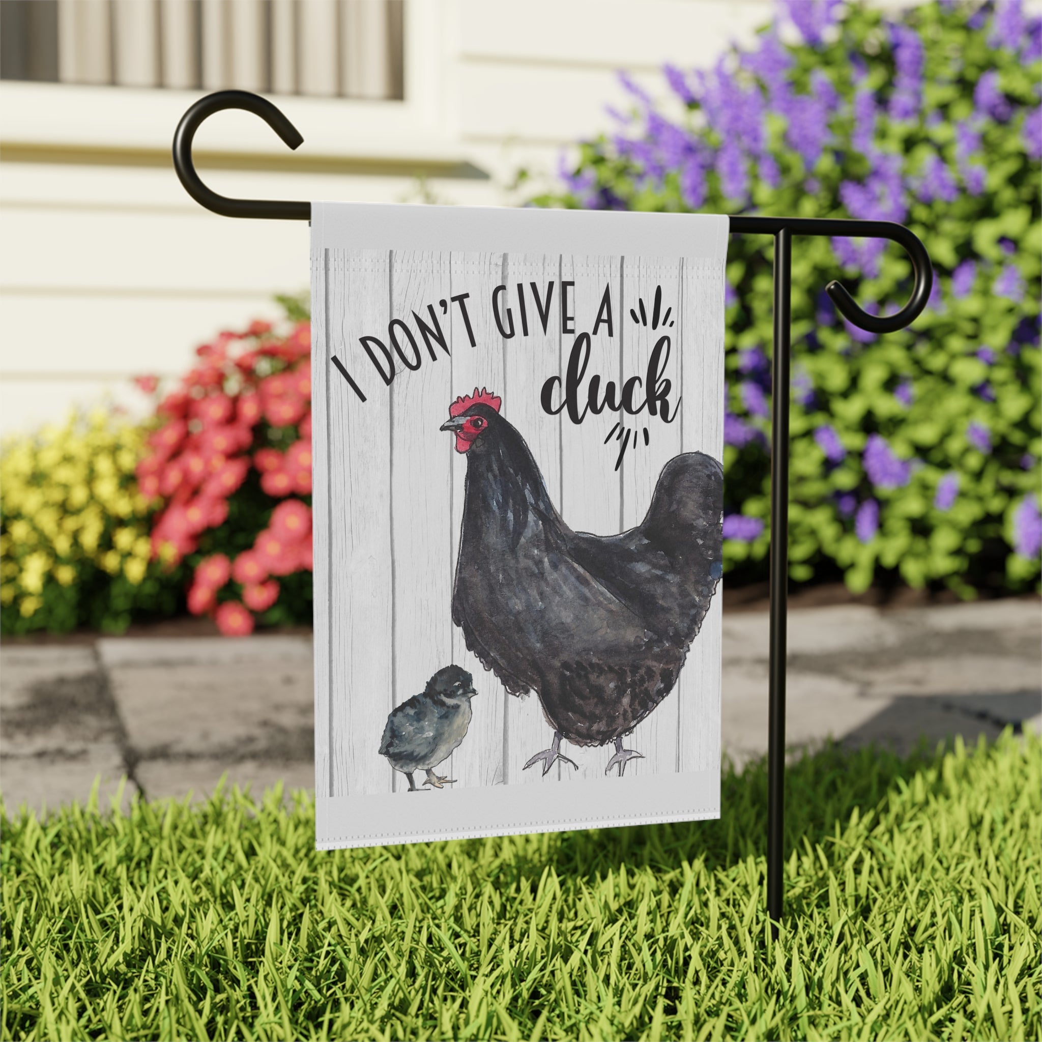 Close-up of Sassy I Don't Give A Cluck garden flag with chicken design detail