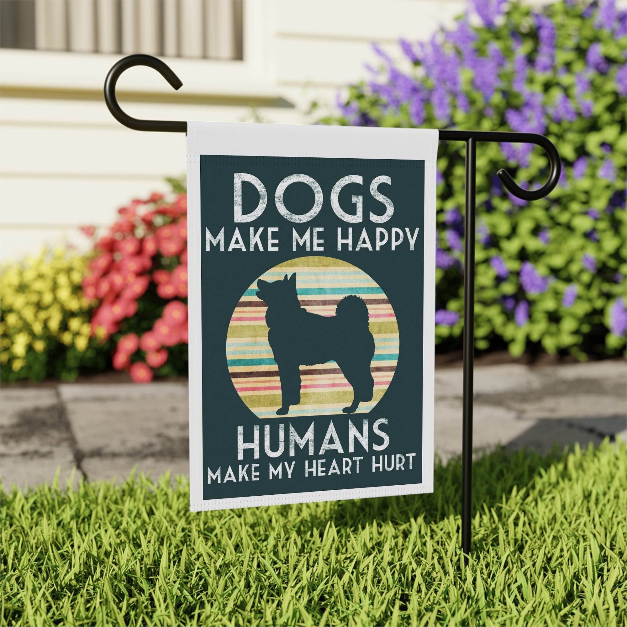Funny dog mom garden flag displayed outdoors on a porch flag stand