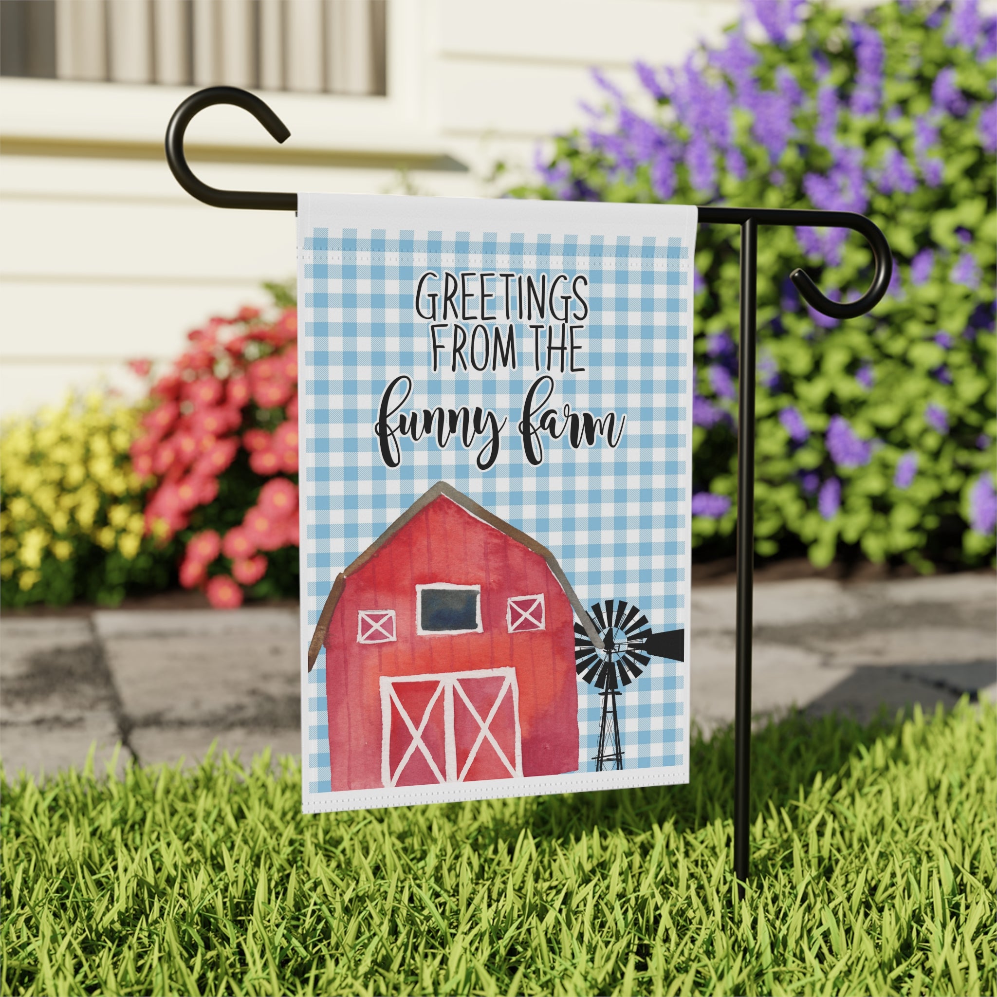 Close-up of Greetings From The Funny Farm garden flag with red barn detail