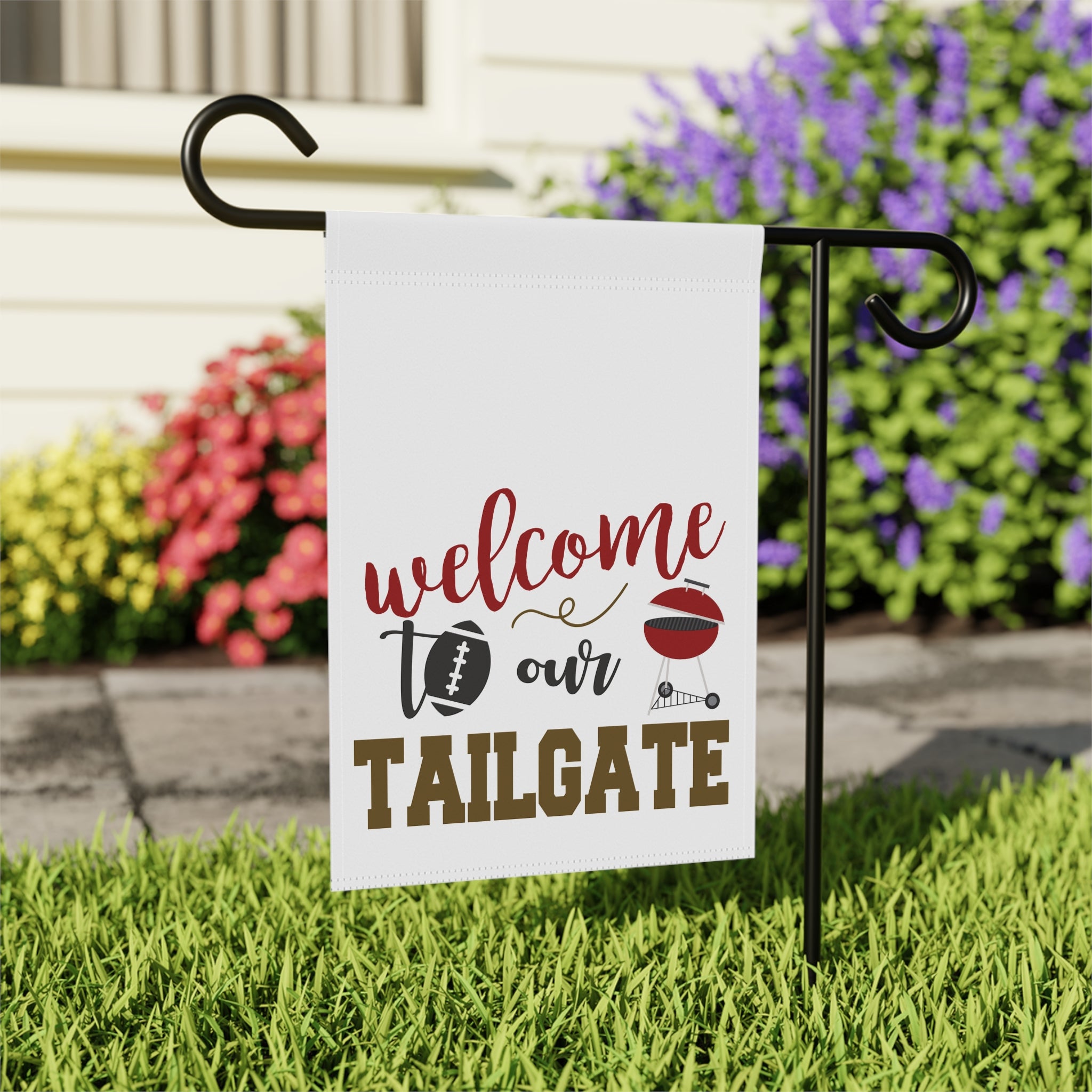 Close-up of Welcome to our Tailgate garden flag with football and BBQ design detail