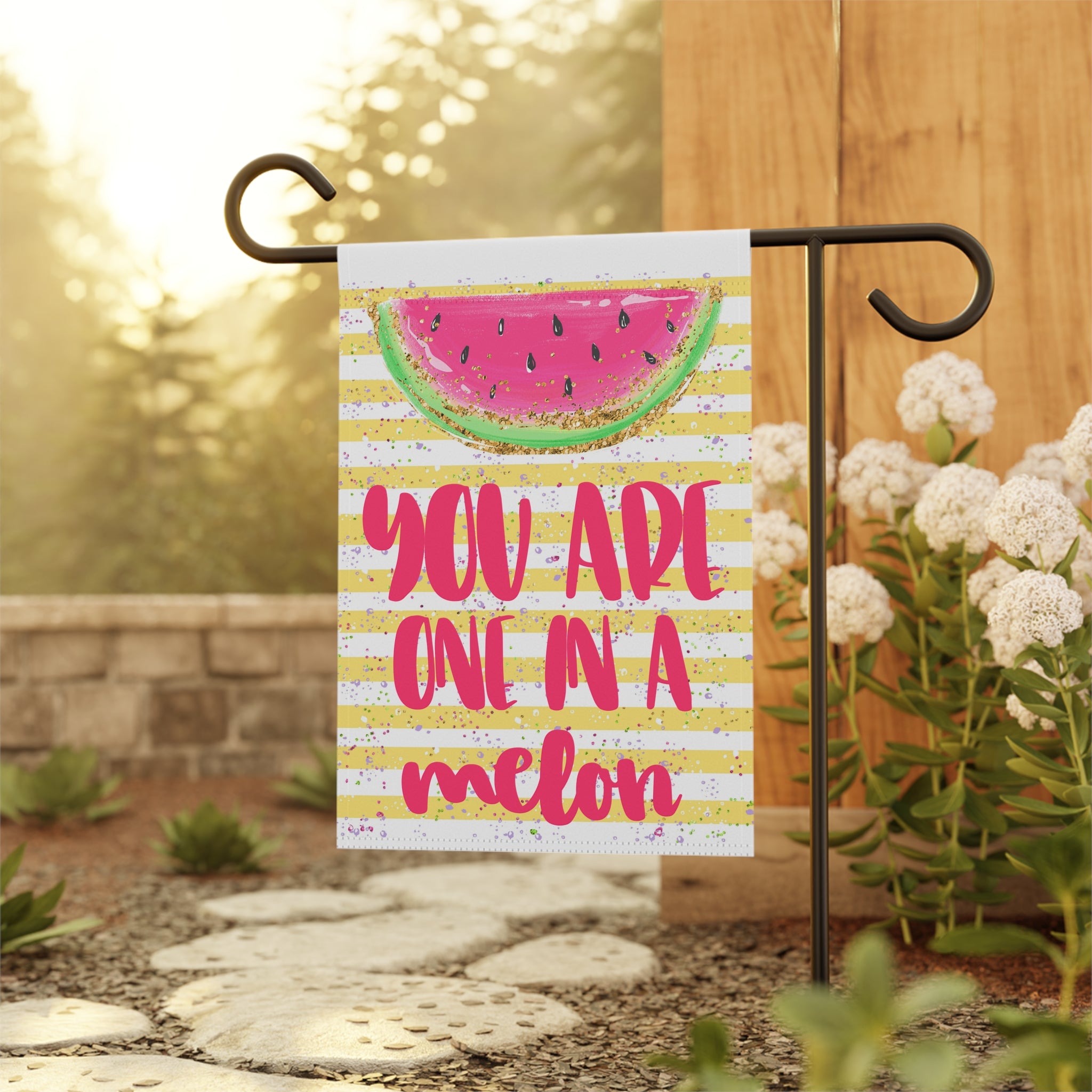 Cute punny watermelon garden flag displayed outdoors on a porch flag stand