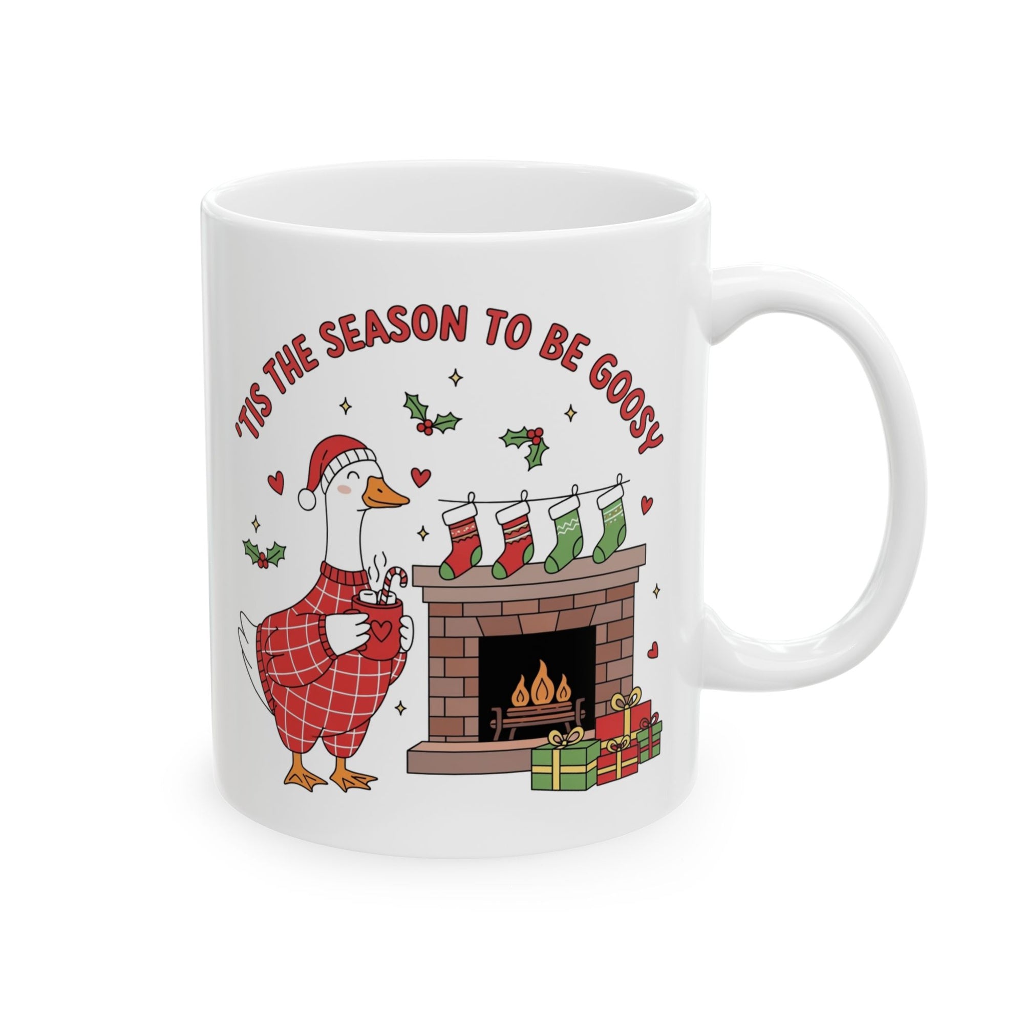 White mug with Christmas design featuring a goose, stockings, and fireplace.