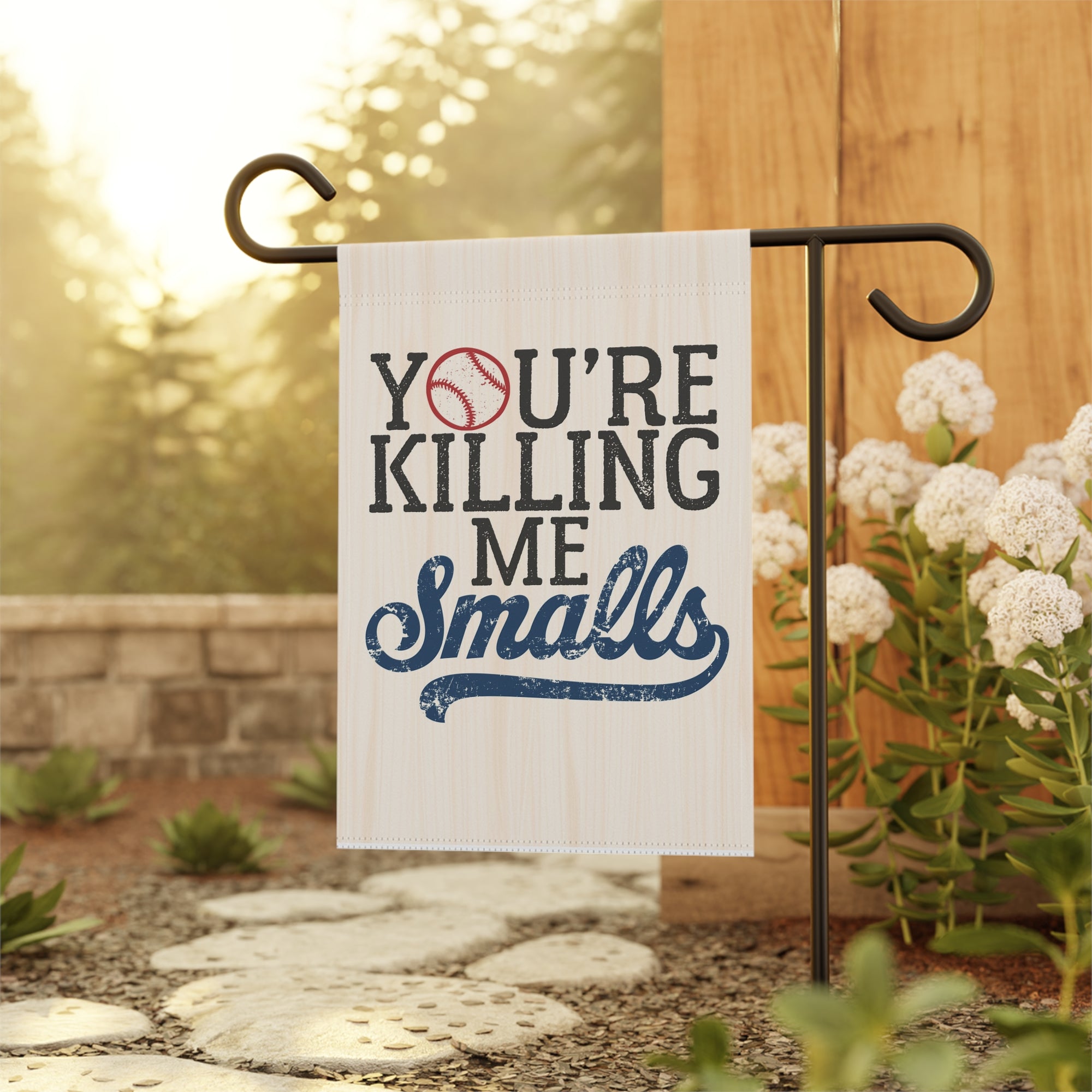 Garden flag with 'You're Killing Me Smalls' text on a stand in the garden.