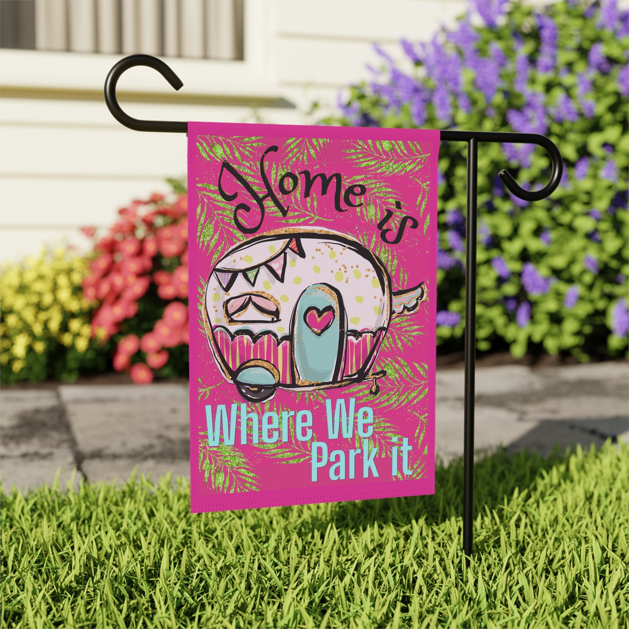 Close-up of Home is Where We Park It garden flag with vintage camper detail