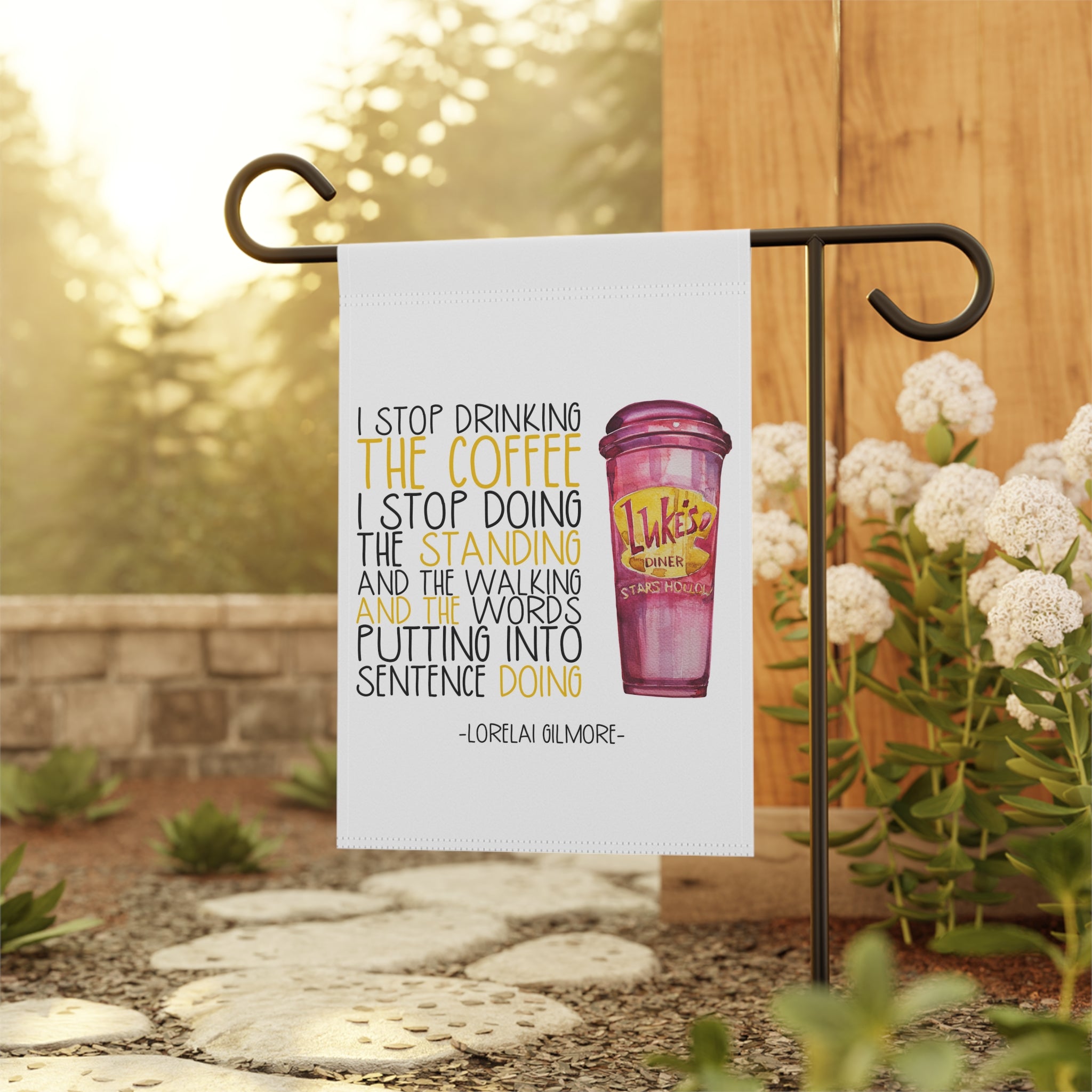 Sassy caffeine garden flag displayed outdoors on a porch flag stand
