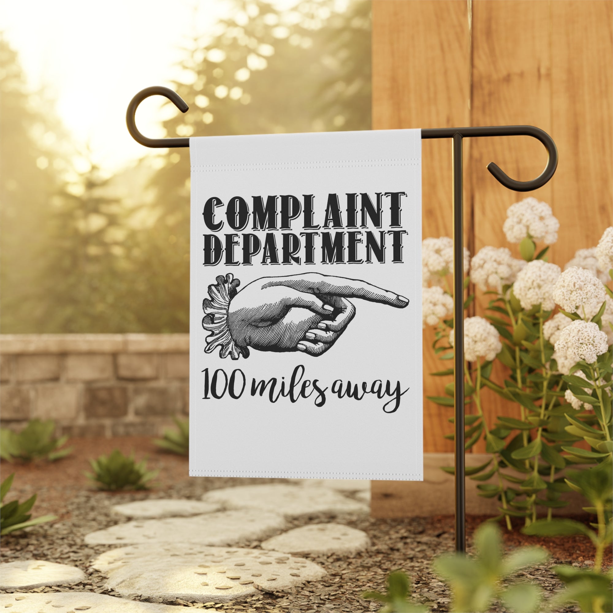 Snarky complaint department garden flag displayed outdoors on a porch flag stand