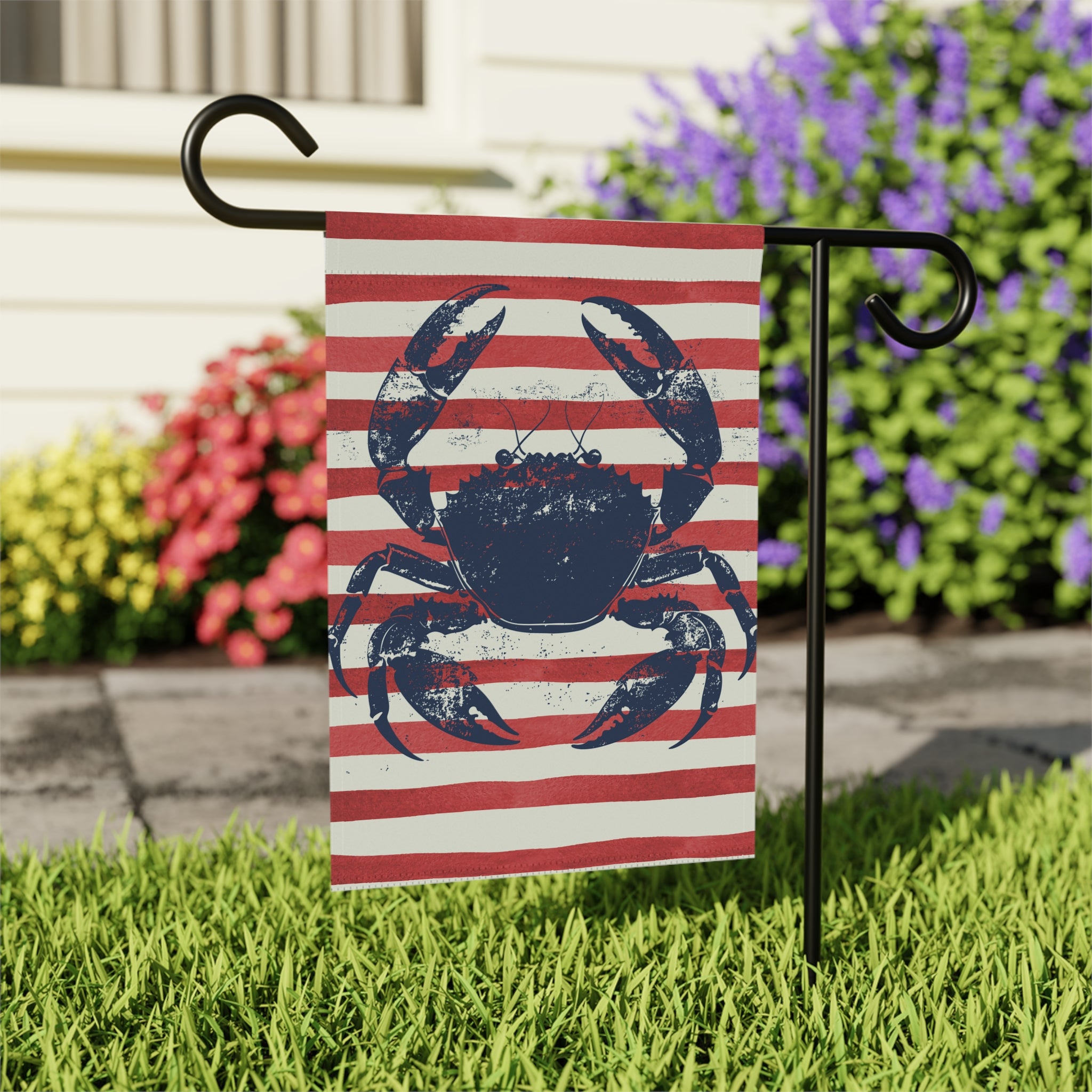 Close-up of weathered blue crab garden flag with New England nautical style