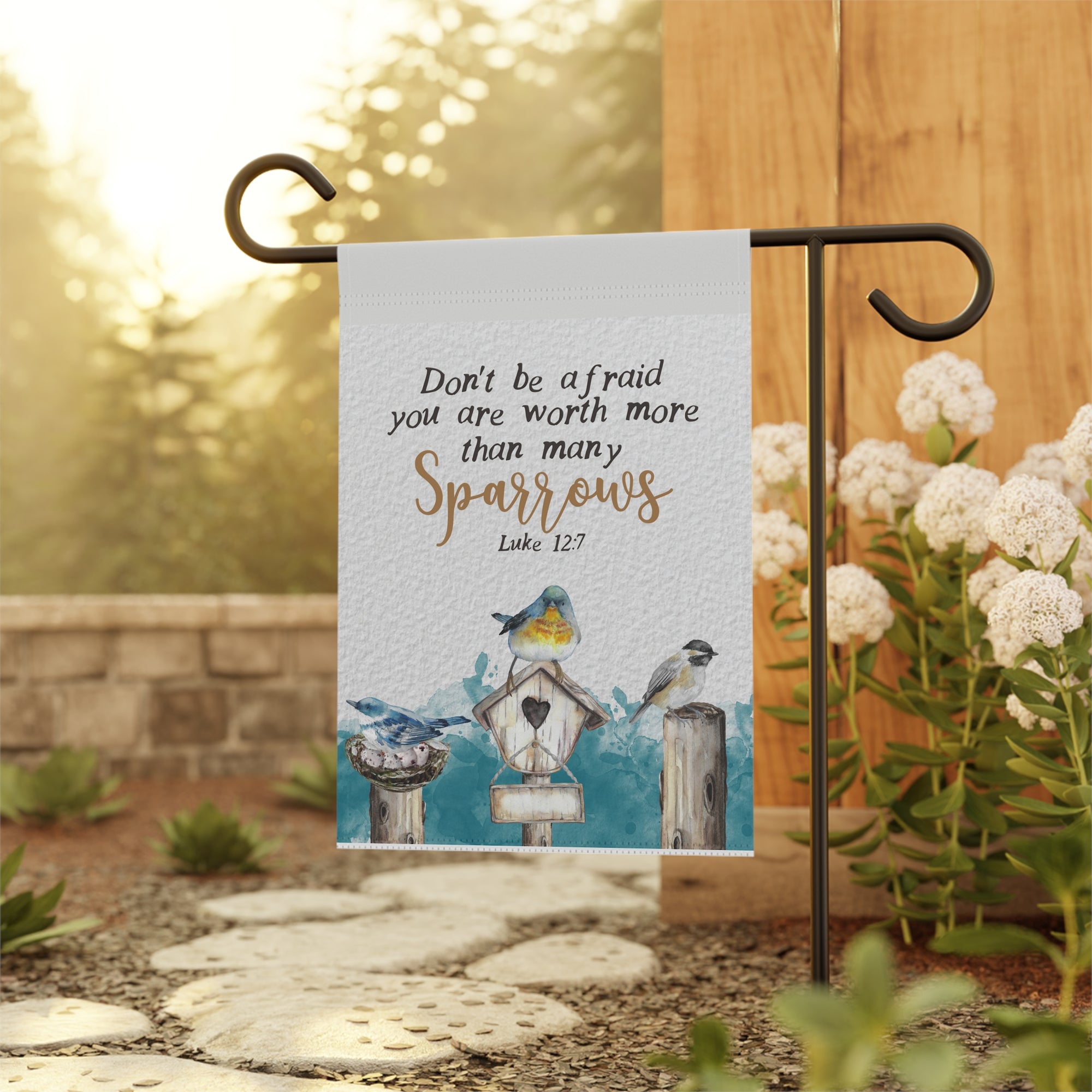 Christian scripture garden flag displayed outdoors on a porch flag stand