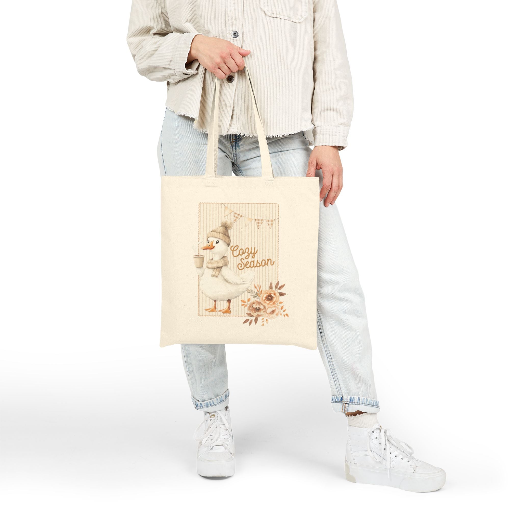 Person holding a tote bag with a design and text on a white background