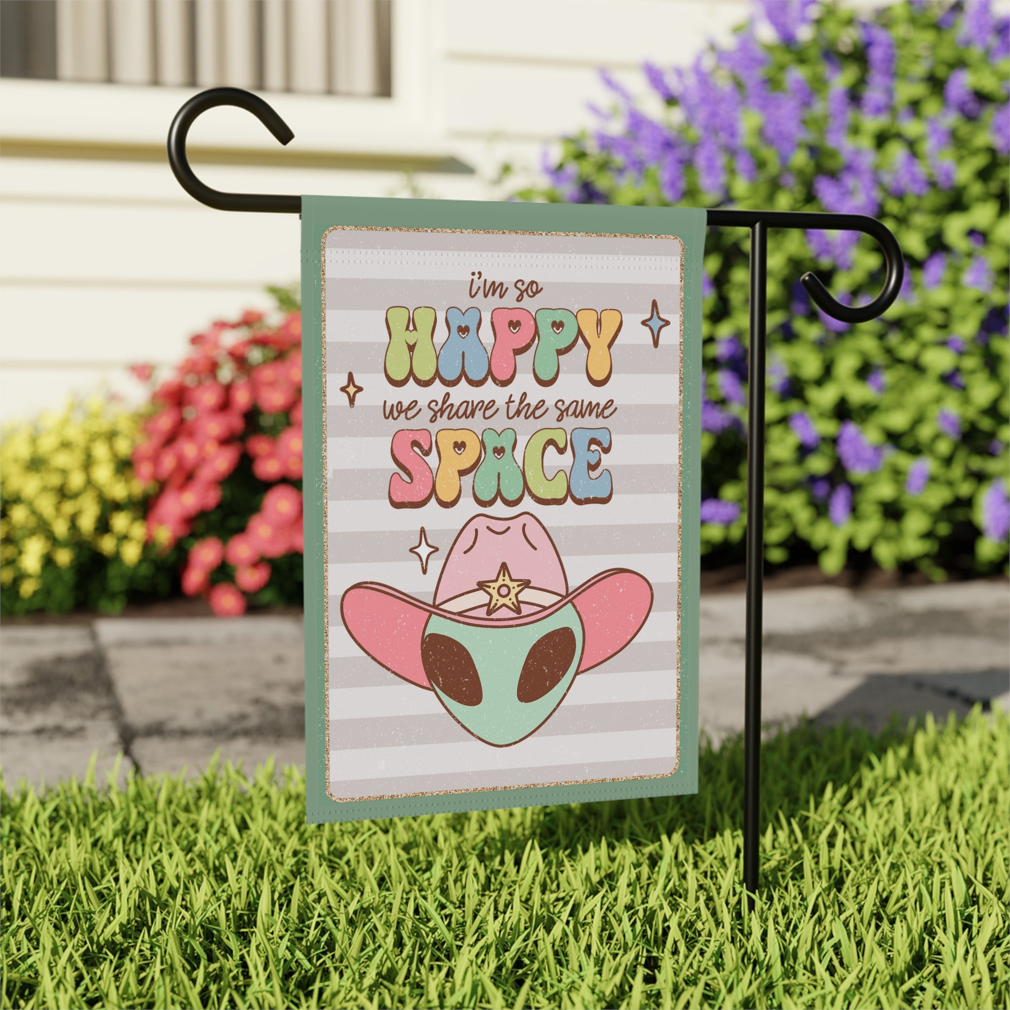 Close-up of Happy We Share The Same Space garden flag with quirky design