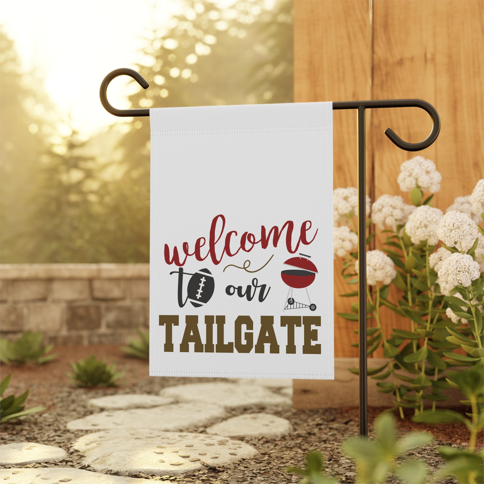 Football tailgate garden flag displayed outdoors on a flag stand at a game day BBQ