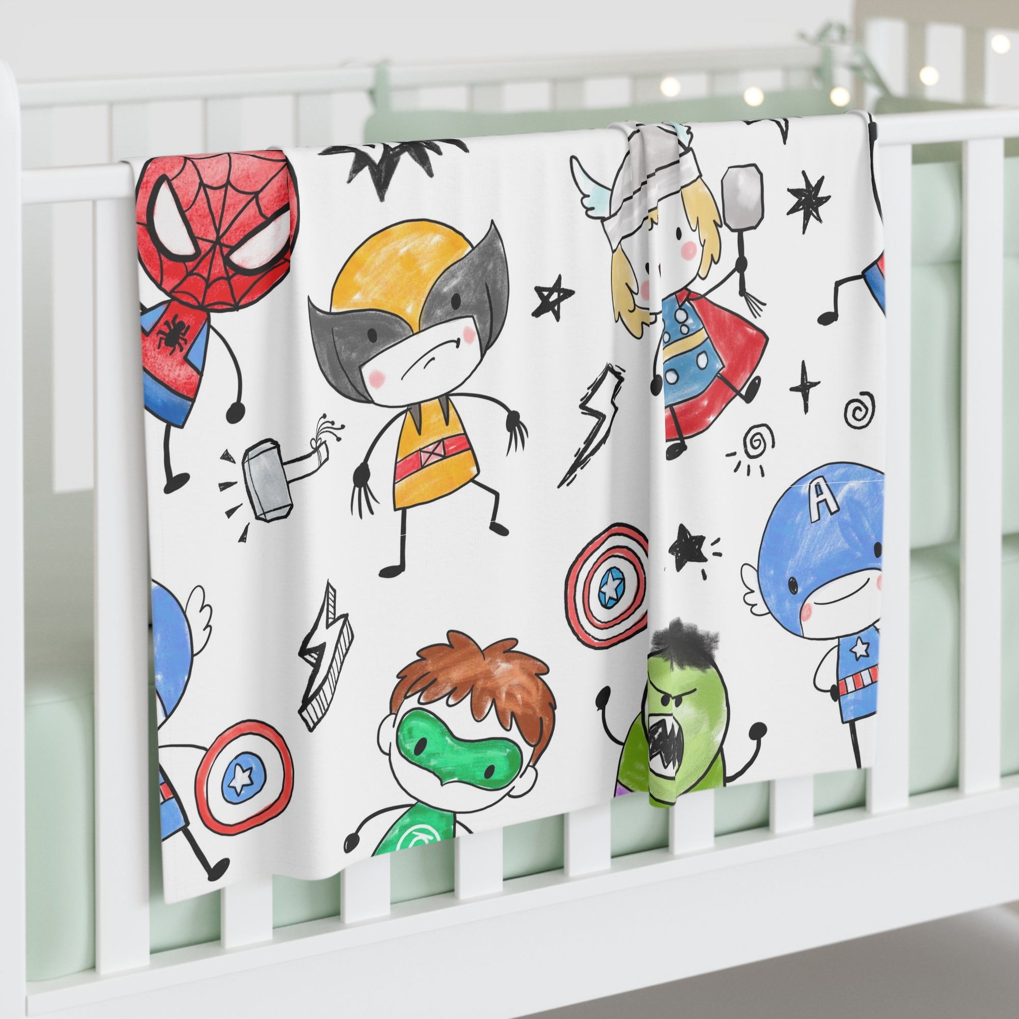 Crib with a superhero-themed blanket featuring cartoon characters on a white background.