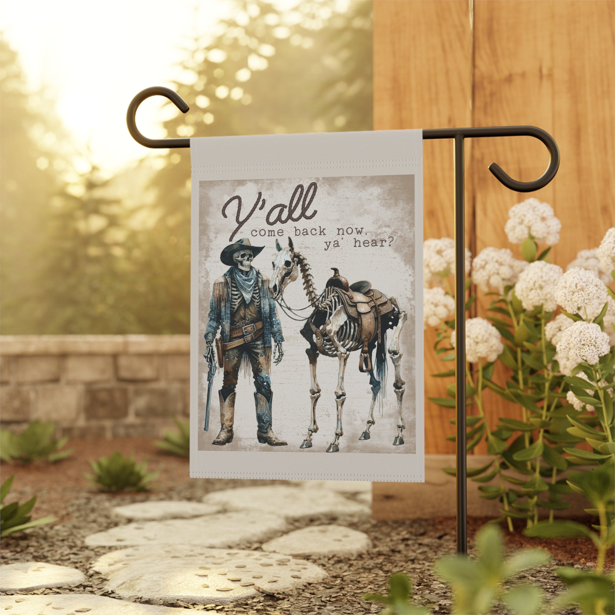 Funny western Halloween garden flag displayed outdoors on a flag stand