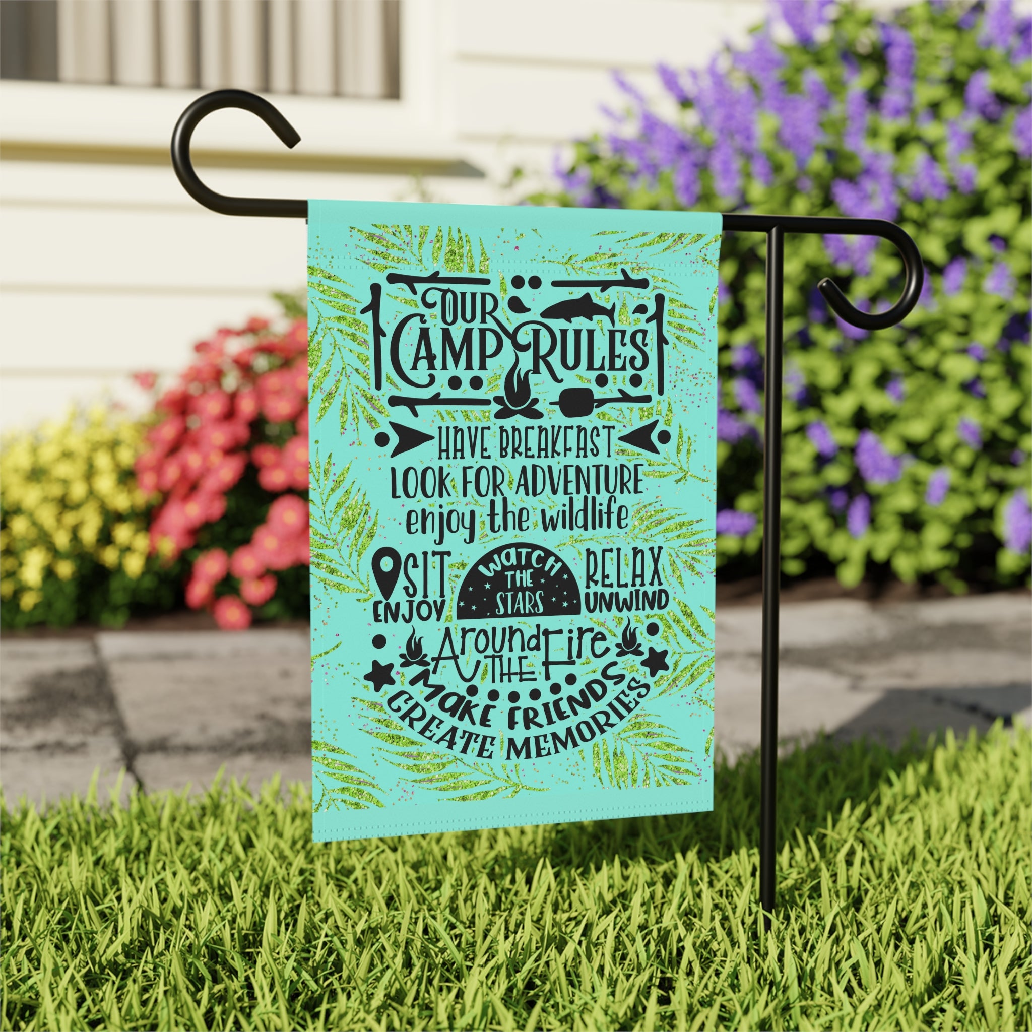 Close-up of Camp Rules garden flag with hand-illustrated camping details
