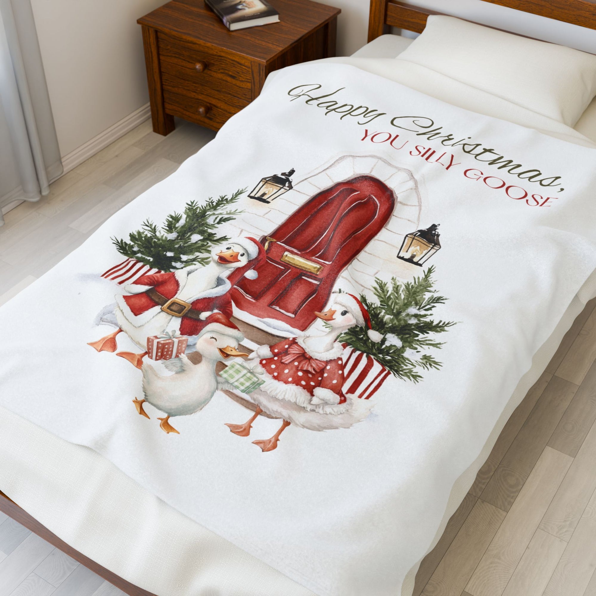 Christmas-themed blanket with Santa Claus and snowmen on a bed in a bedroom.