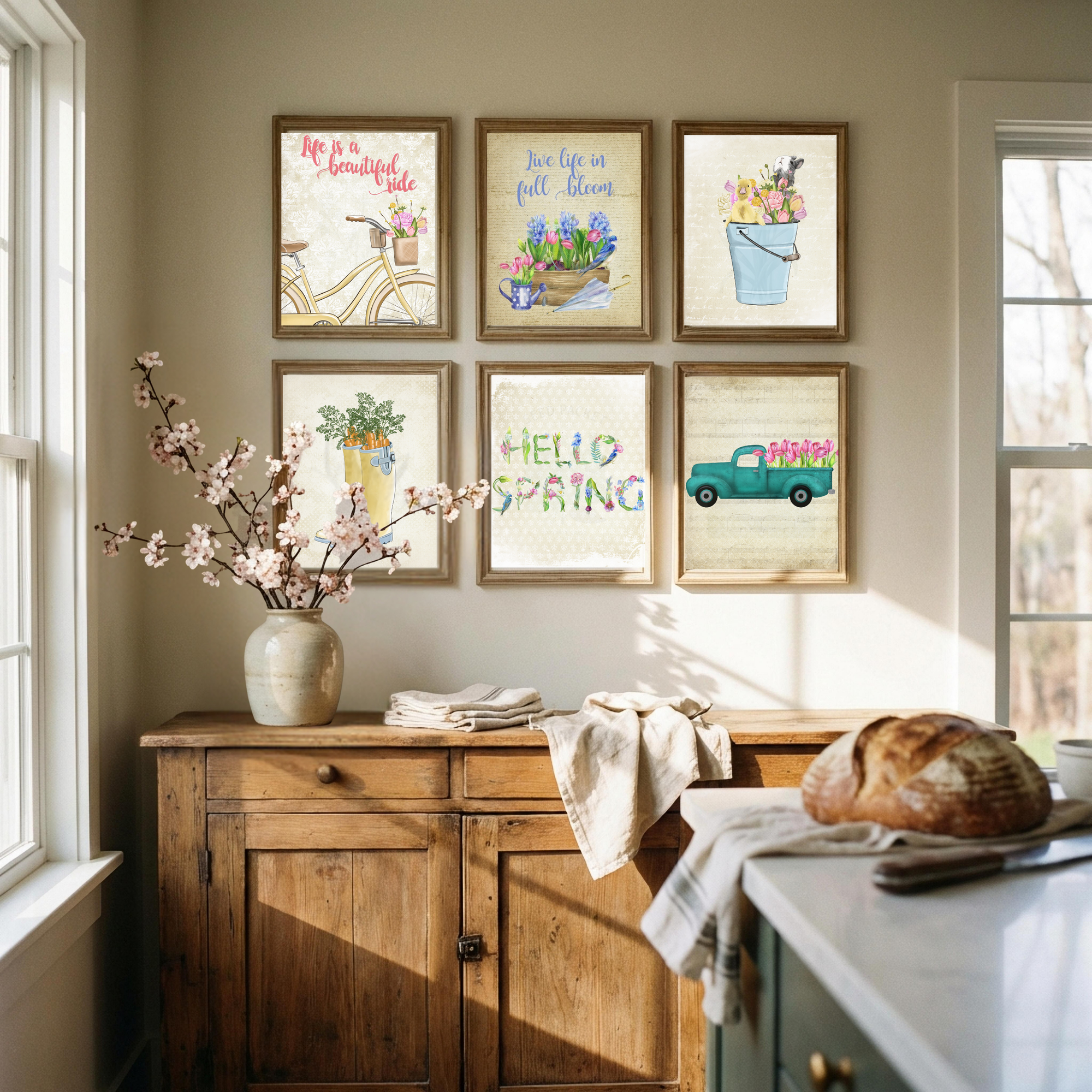 Kitchen interior with wooden cabinets, a vase of flowers, and framed spring-themed prints on the wall.