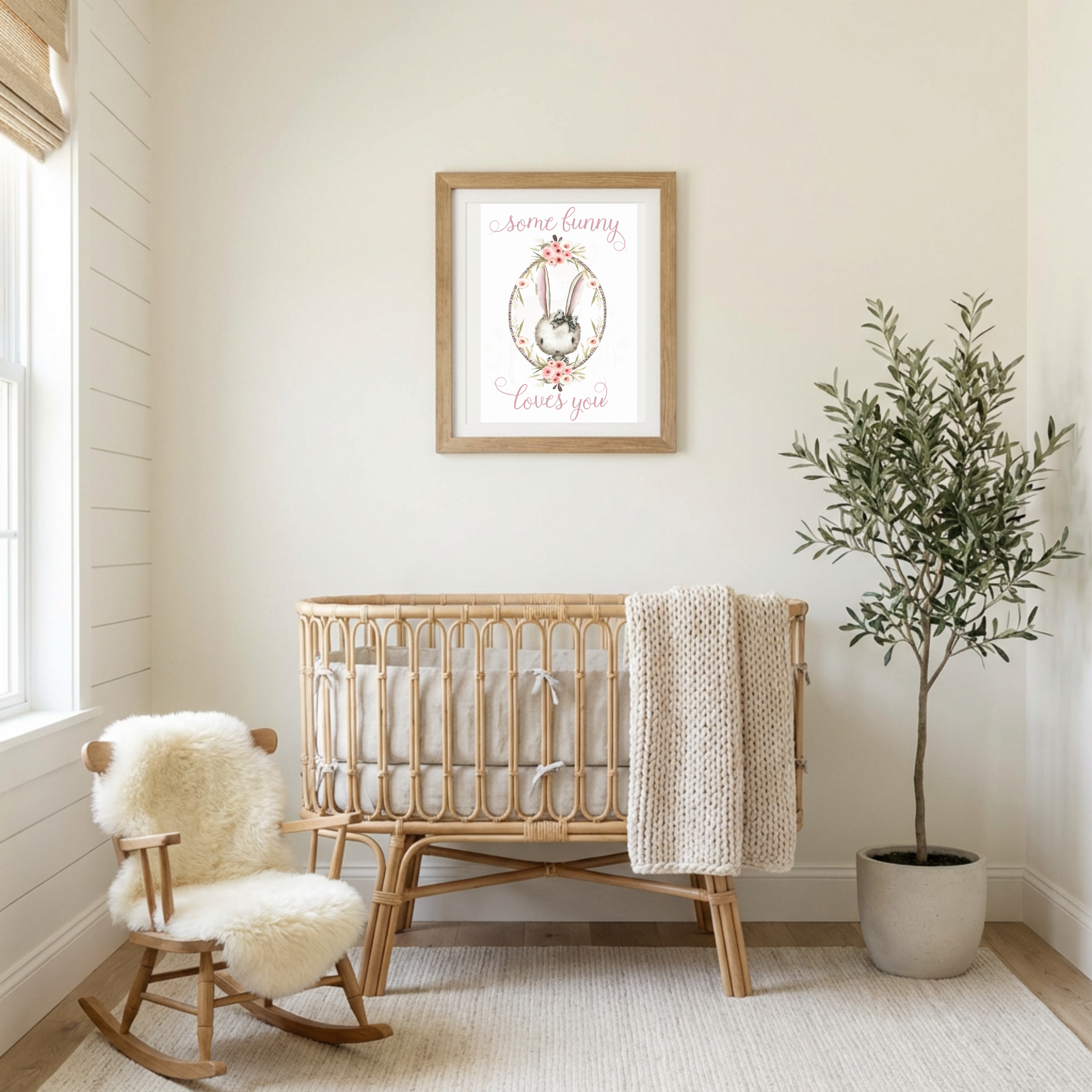 Nursery room with wooden crib, rocking chair, and framed artwork on the wall.