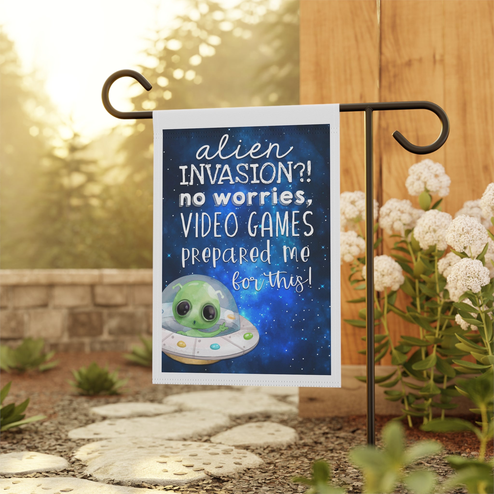 Funny gamer alien garden flag displayed outdoors on a porch flag stand