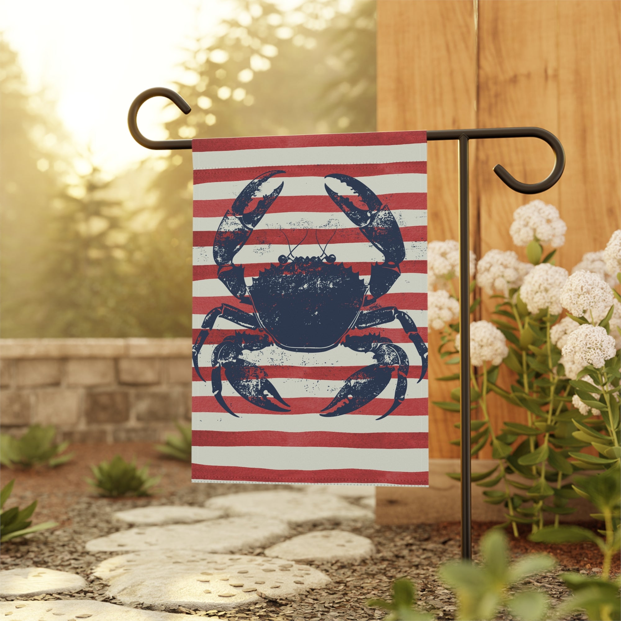 Coastal crab garden flag displayed outdoors on a flag stand