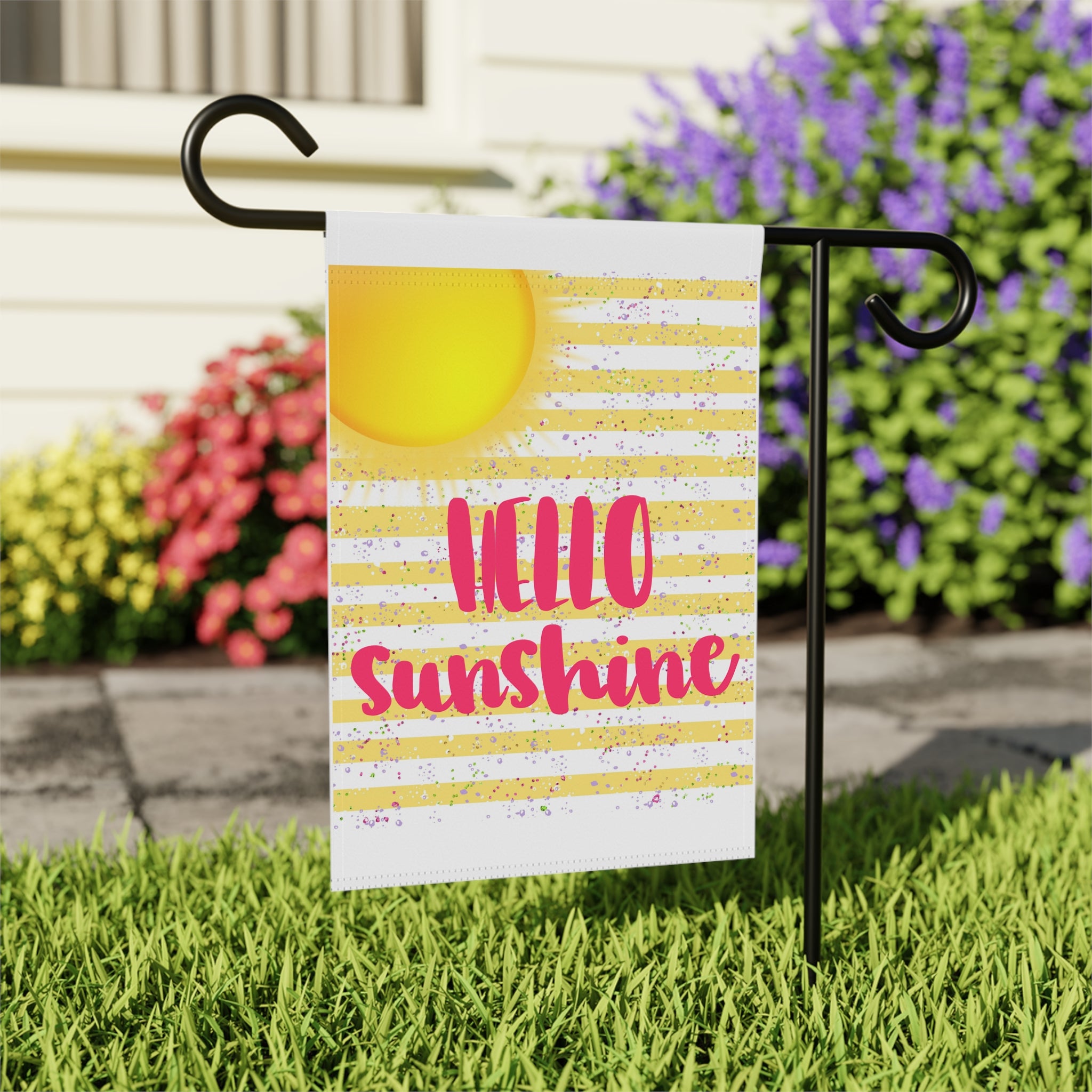 Close-up of Hello Sunshine garden flag with yellow sunshine typography detail
