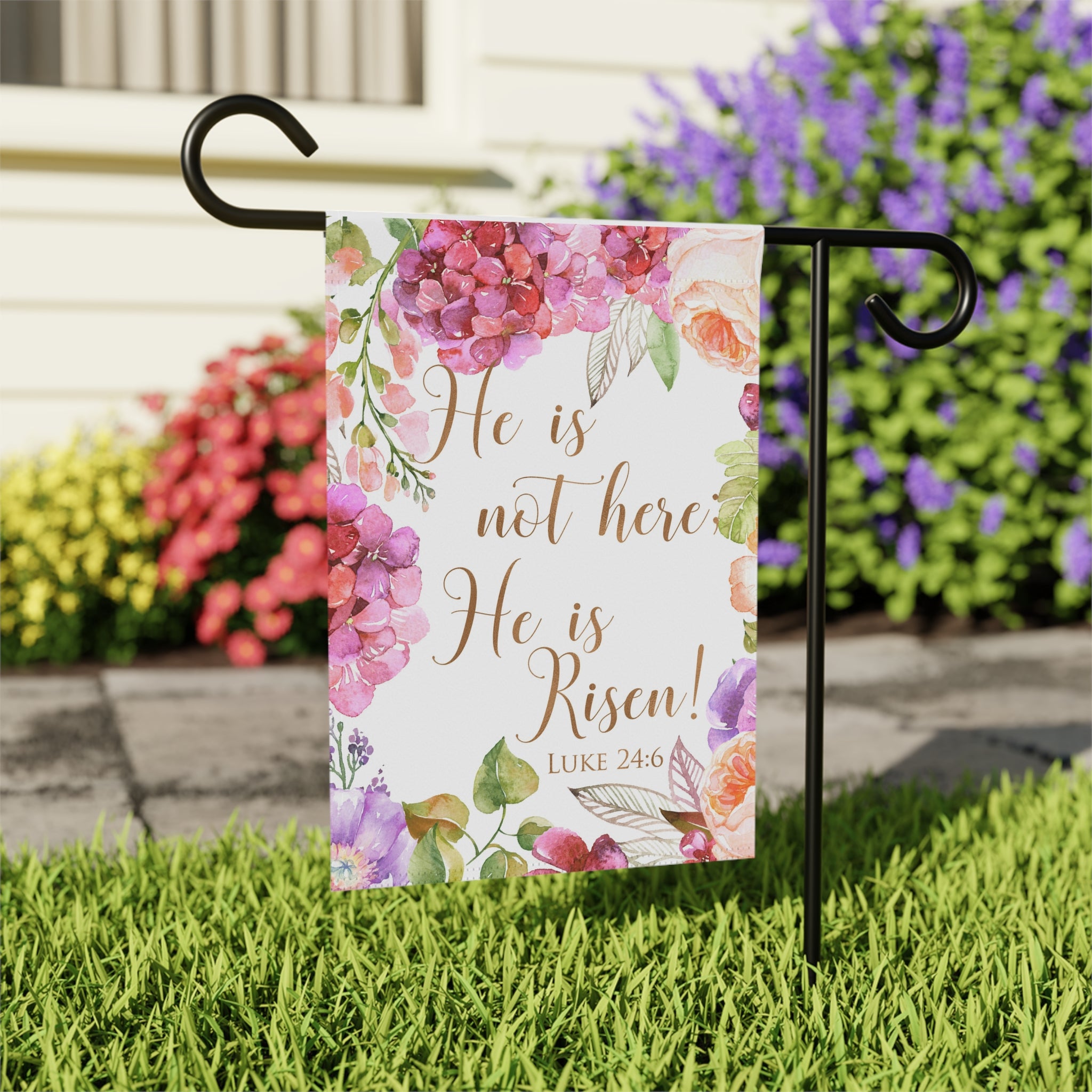 He Is Risen Easter garden flag displayed outdoors on a flag stand