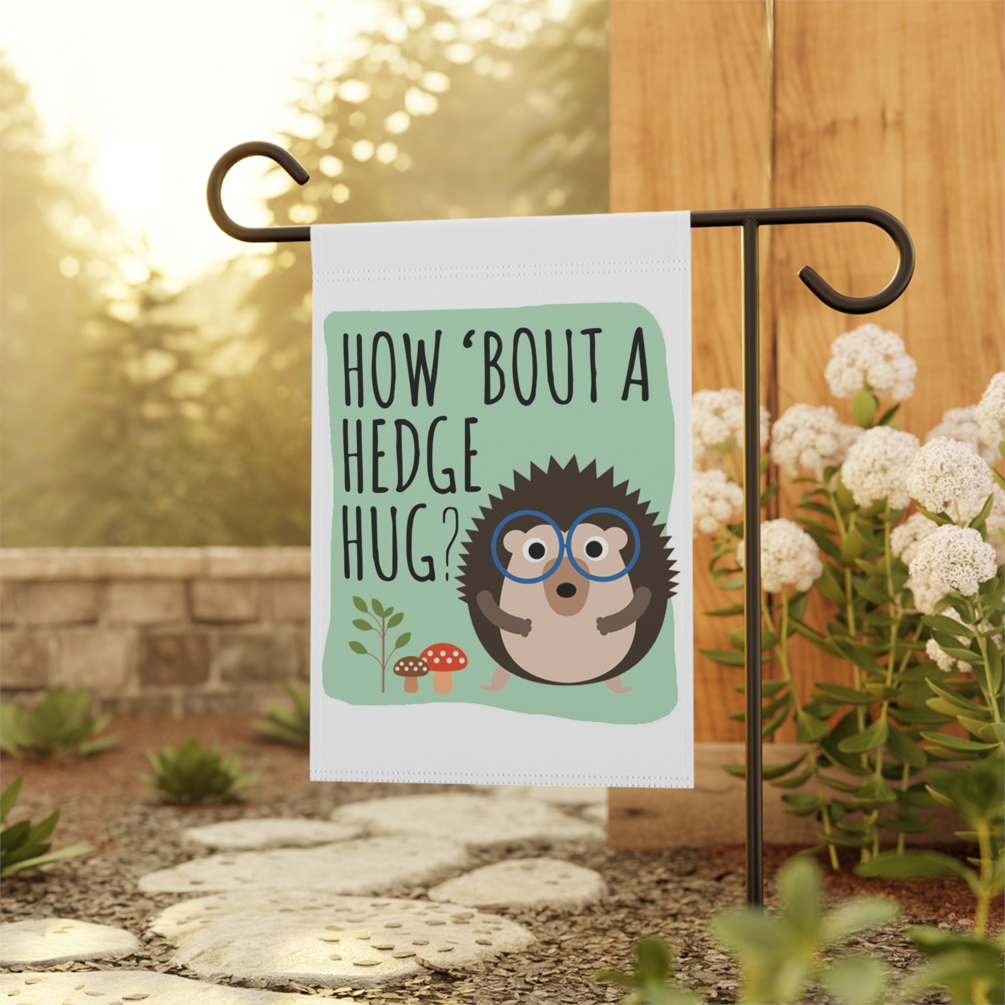 Punny hedgehog garden flag displayed outdoors on a flag stand