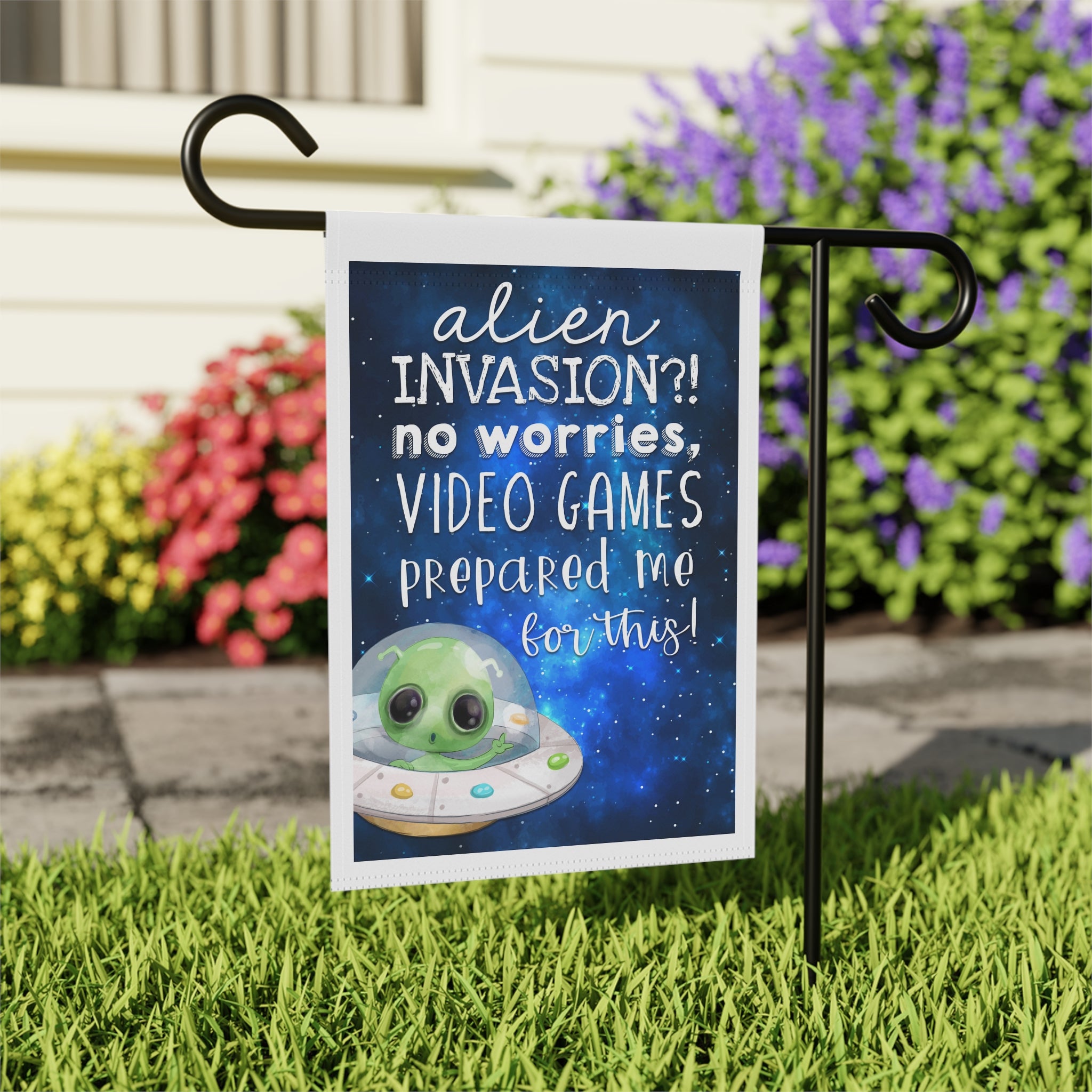 Close-up of Alien Invasion No Worries garden flag with sci-fi design