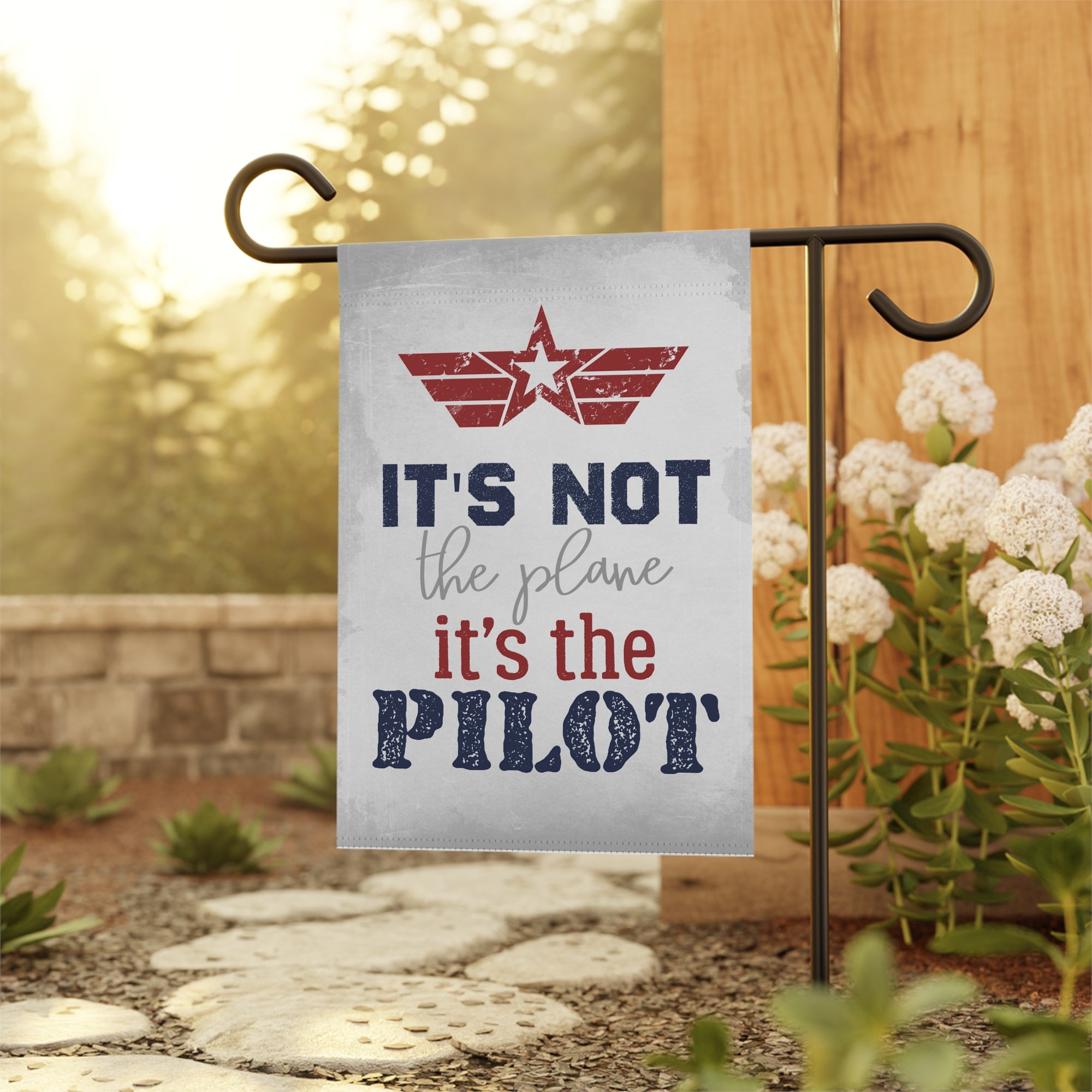Garden flag with movie motivational quote on a stand outdoors.