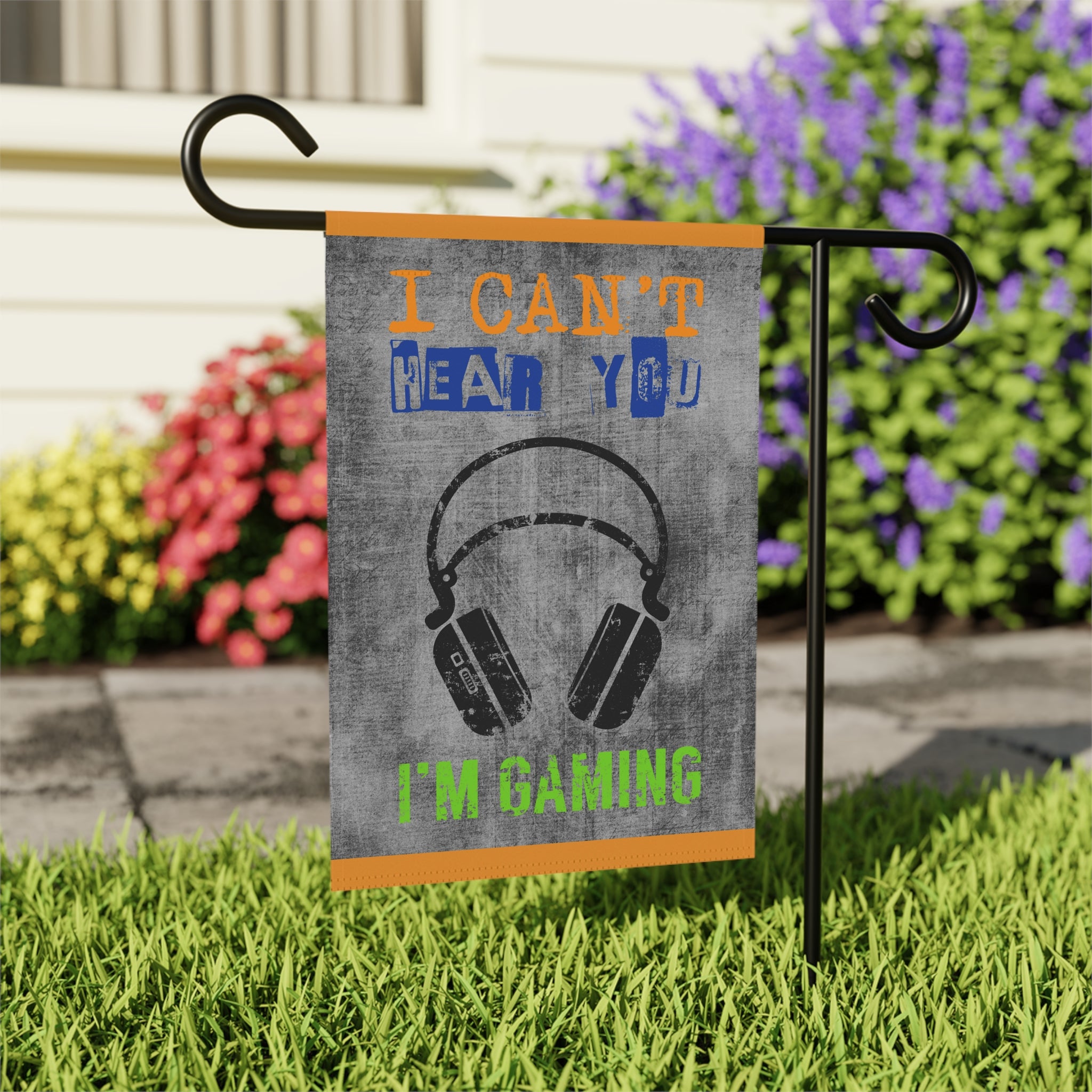 Close-up of I Can't Hear You I'm Gaming garden flag with retro game controller detail