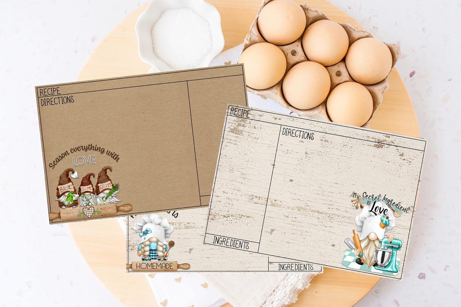 A set of vintage style recipe cards with a rustic design, featuring a small illustration of a goose and decorative elements such as stars and flowers. The cards have a title and a list of ingredients for a recipe written on them.