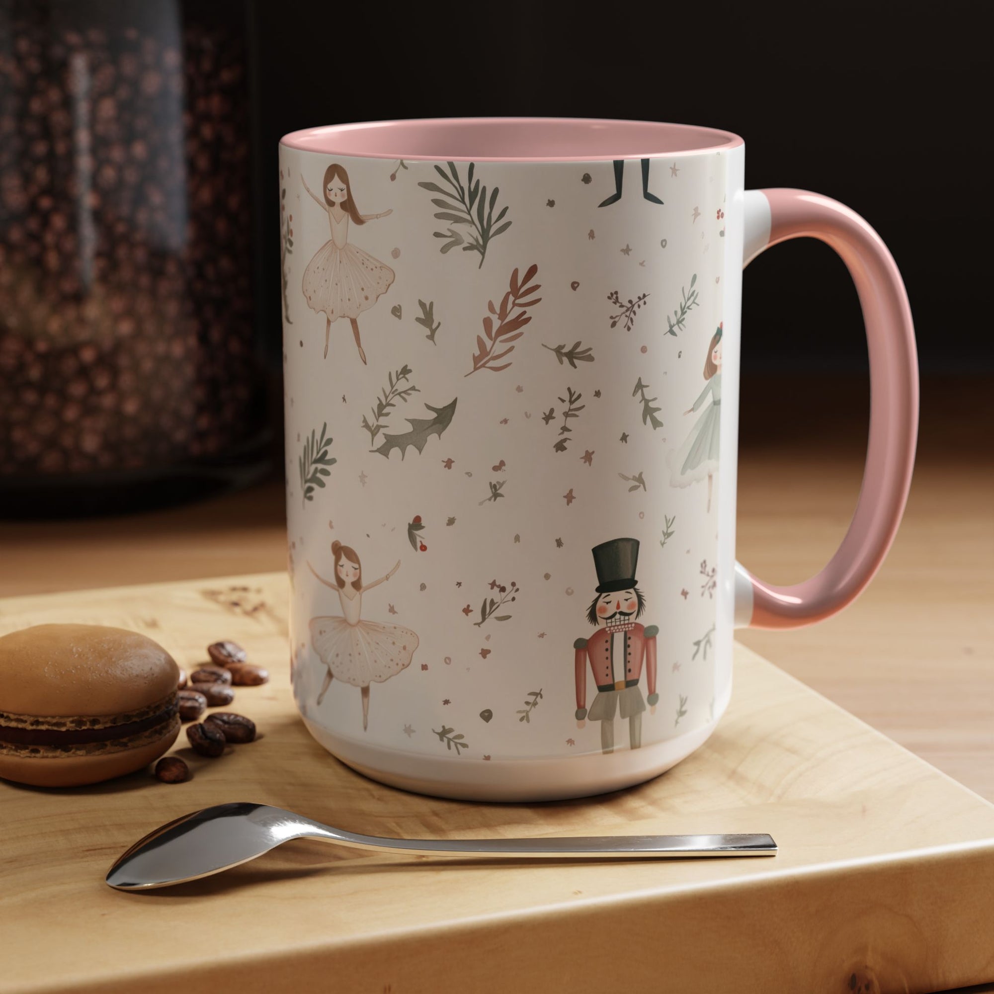 Decorative mug with illustrations on a wooden surface with coffee beans and a macaron.