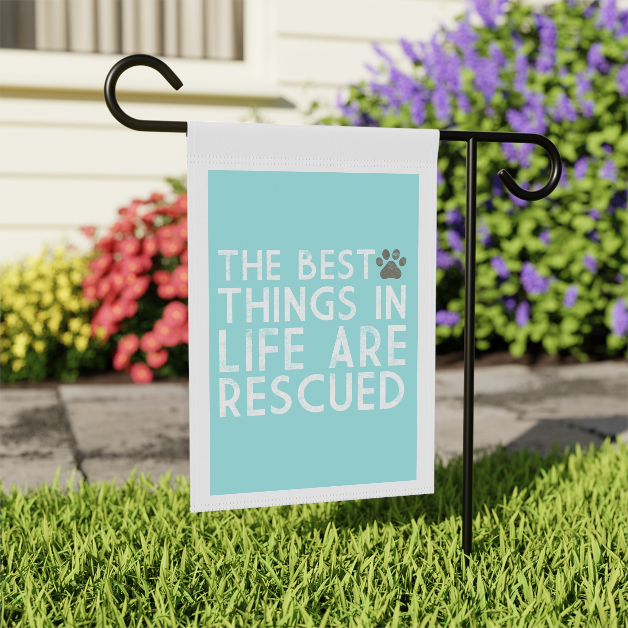 Close-up of The Best Things in Life Are Rescued garden flag with paw print detail