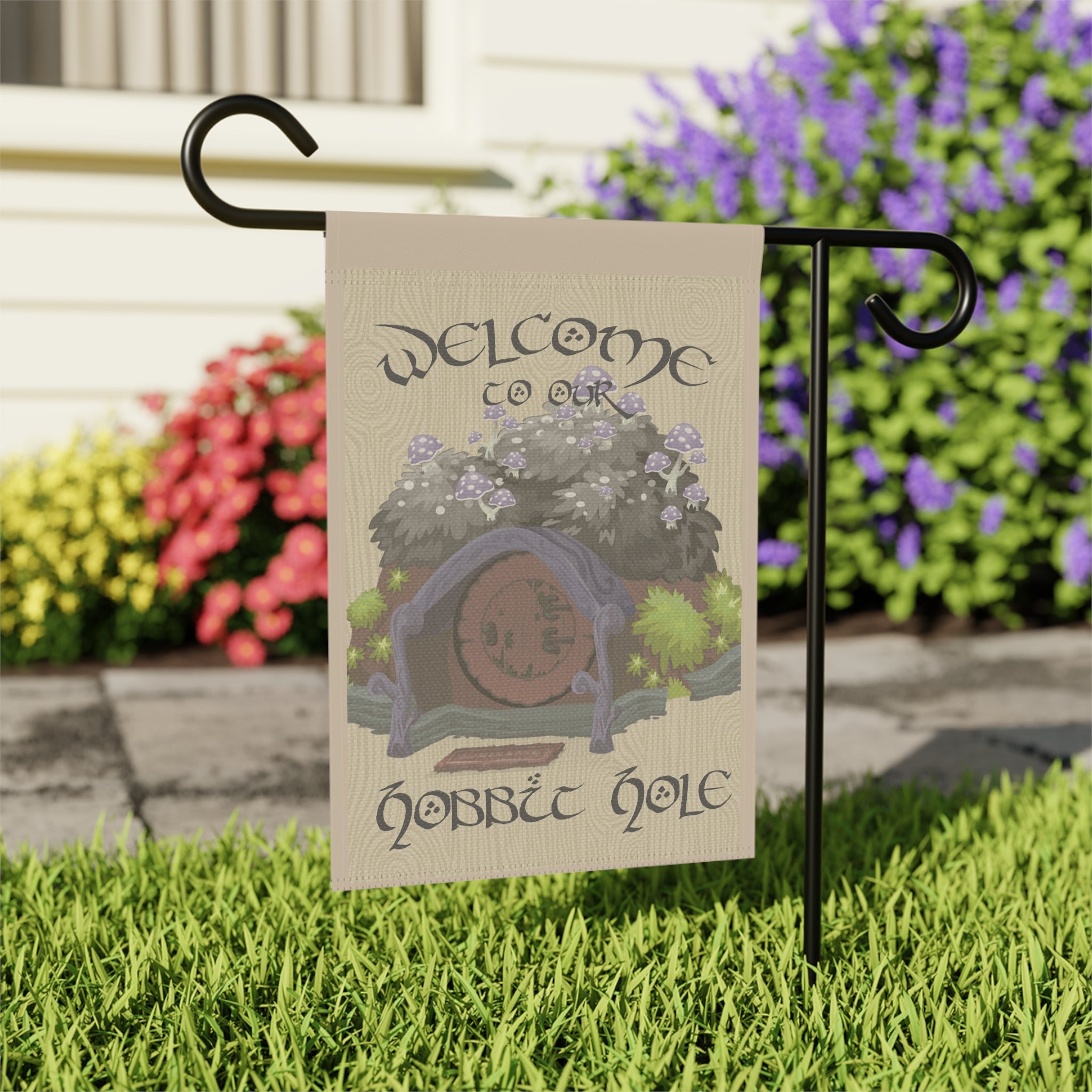 Close-up of Welcome to our Hobbit Hole garden flag with wood-look storybook detail