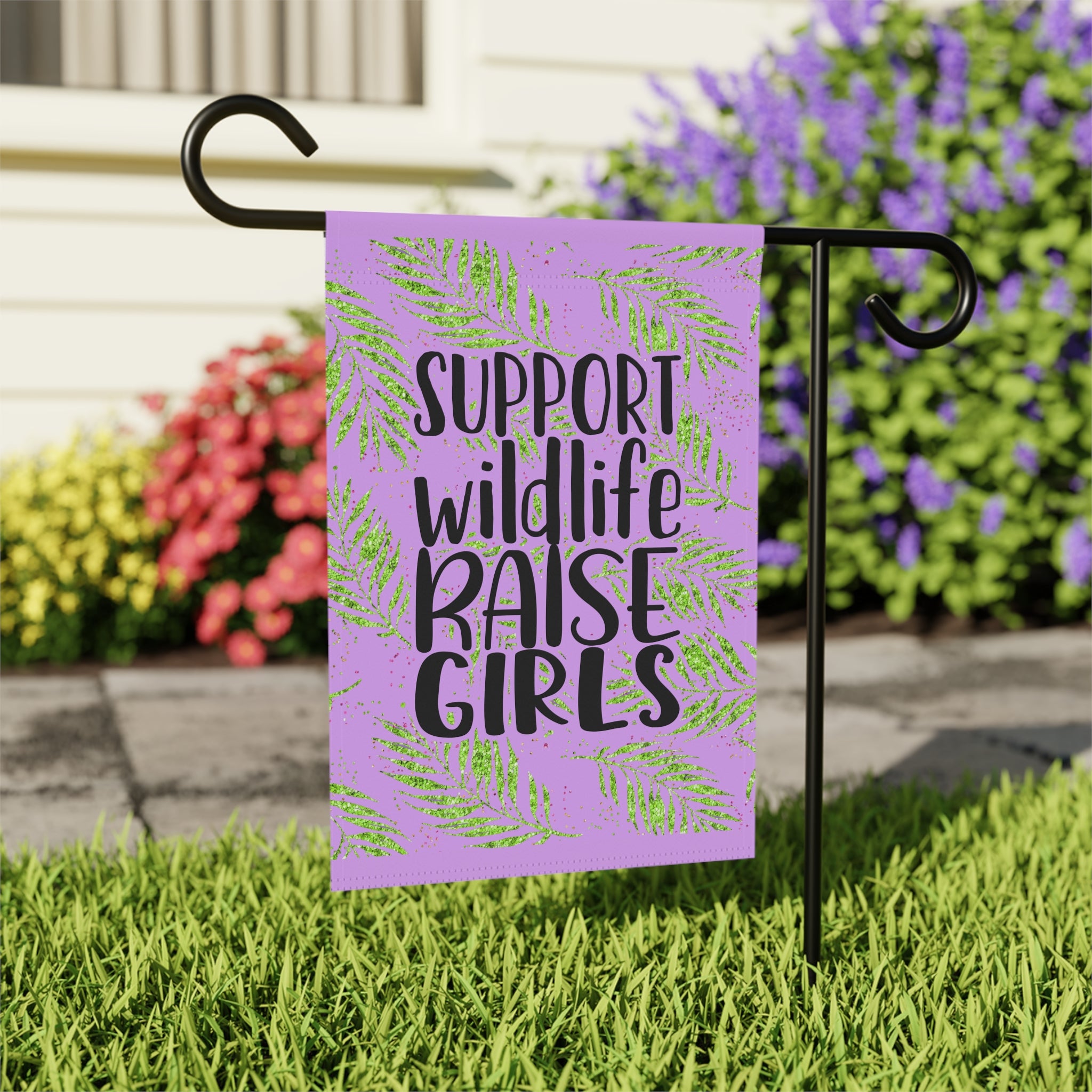 Close-up of Support Wildlife Raise Girls garden flag with sassy design detail