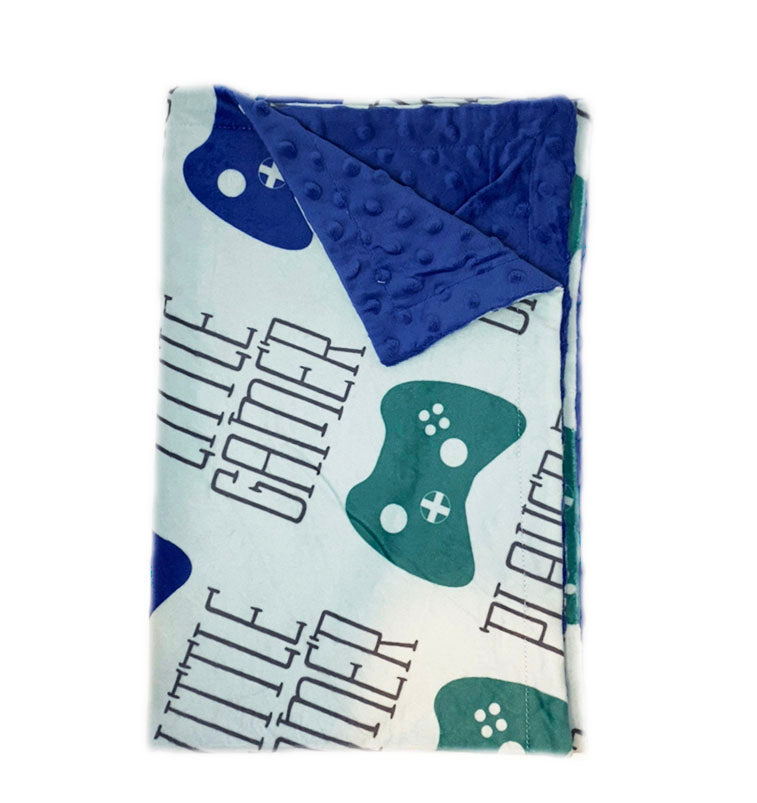 Baby blanket with 'Little Gamer' text and game controller design on a white background