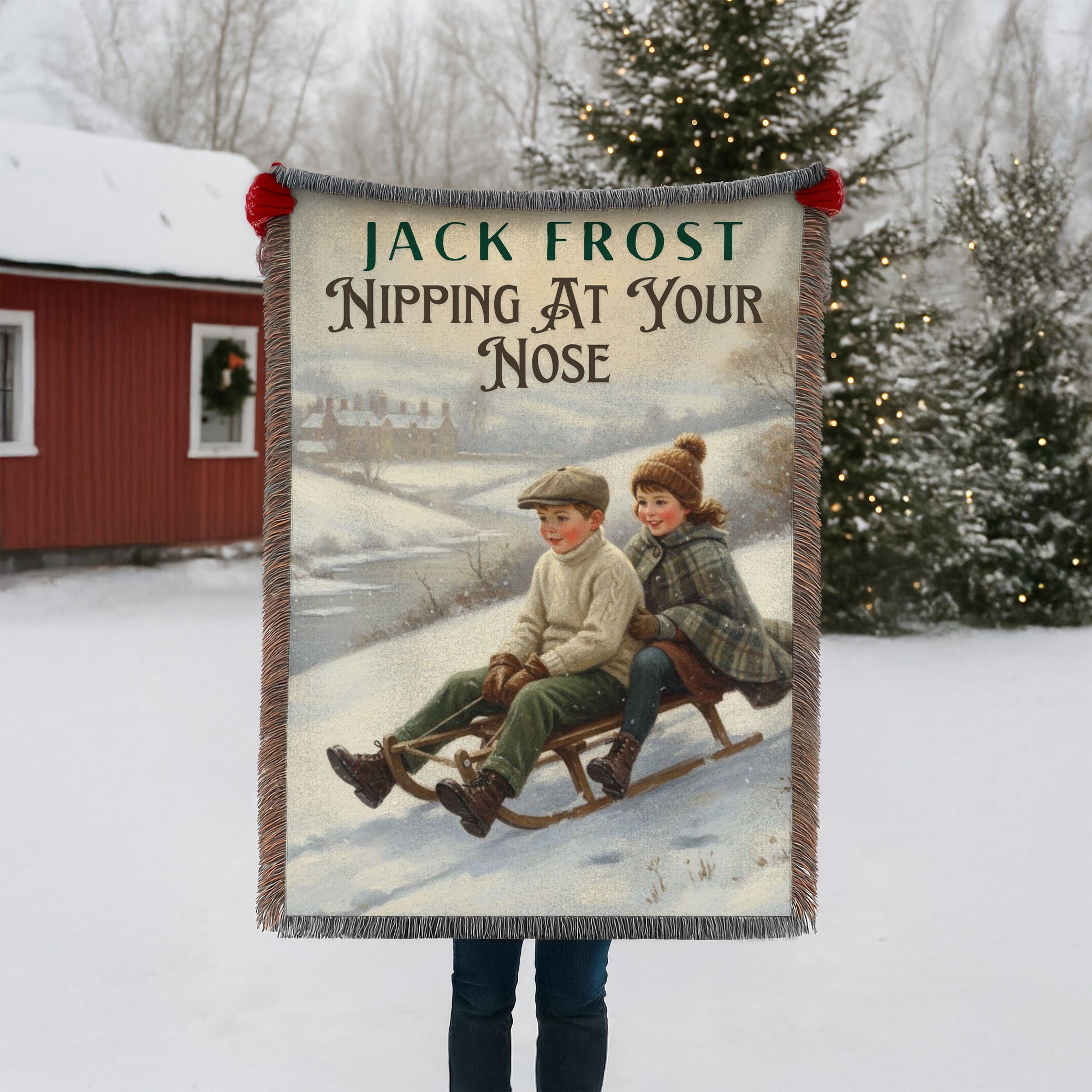Blanket with winter scene and text 'Jack Frost Nipping At Your Nose' held by a person in a snowy landscape.