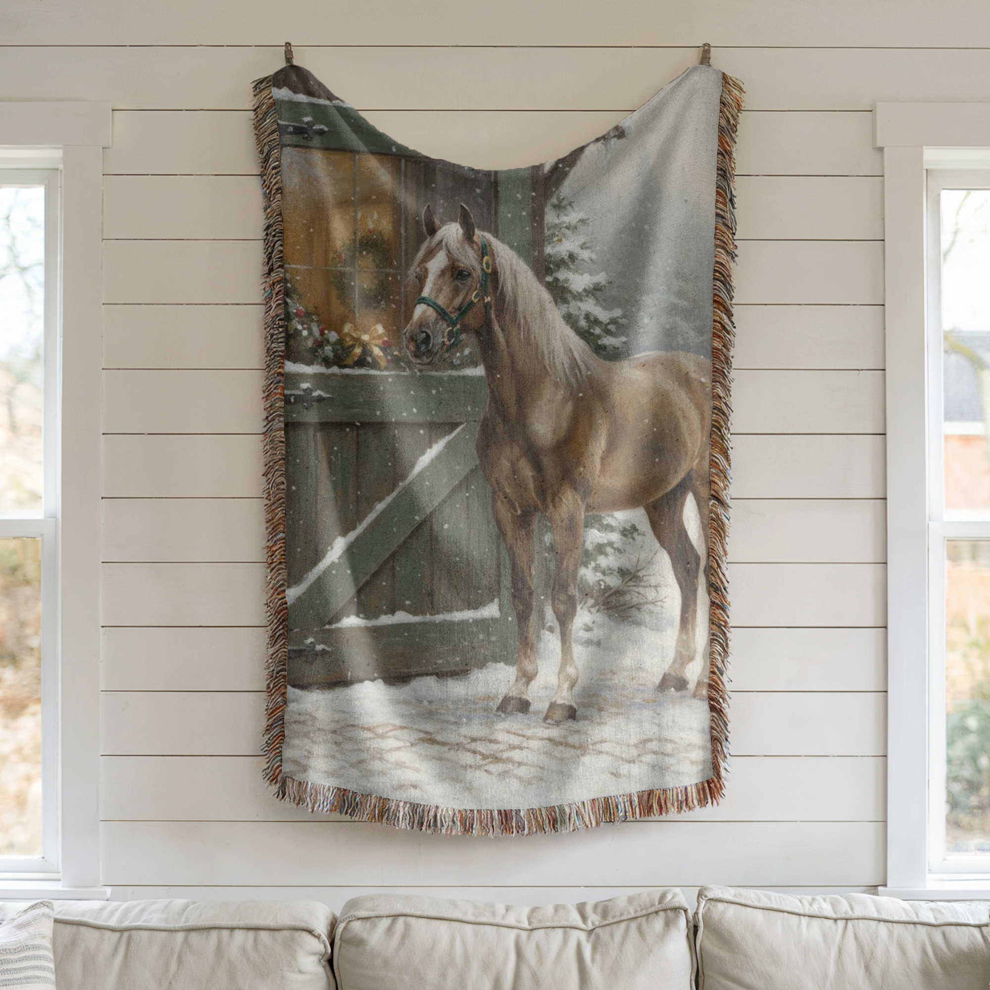 Woven blanket with a horse design hanging on a wall.