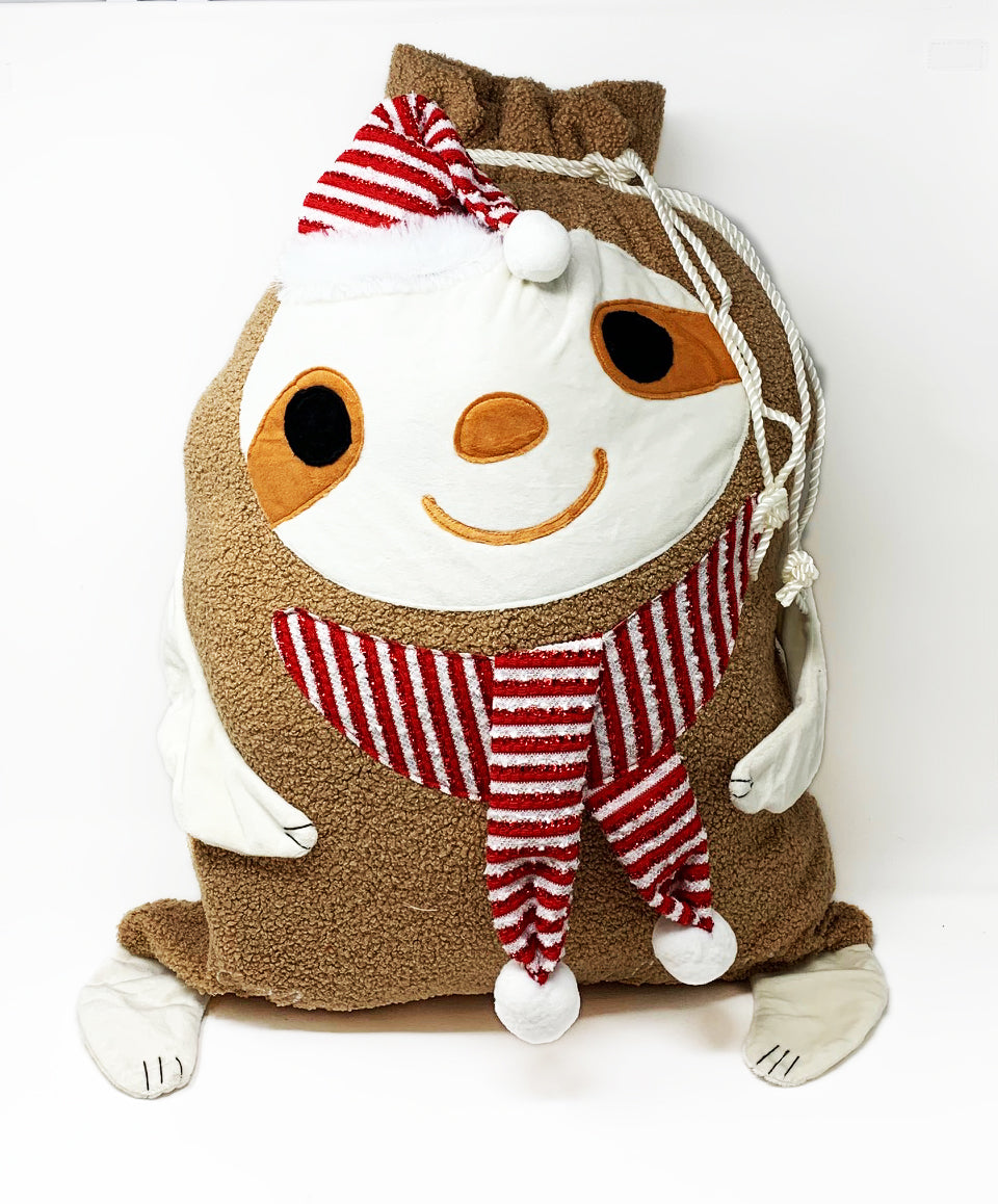 Large soft fleece sloth Christmas gift bag with a drawstring top and embroidered sloth face and accents, shown standing upright.