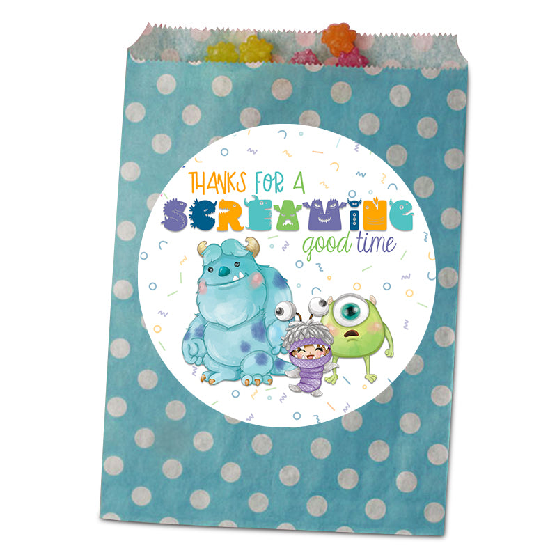 A blue paper party favor bag with white polka dots and a large circular white label on the front. The label features colorful text reading 'THANKS FOR A SCREAMING good time' above cartoon characters from Monsters Inc.