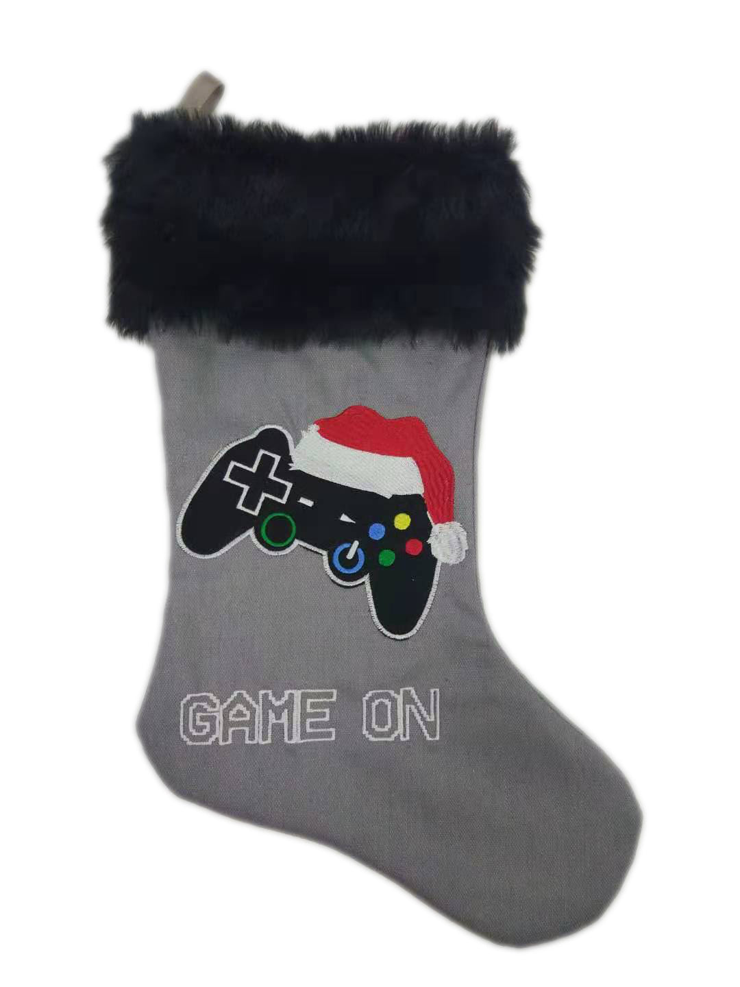 Game On! video gamer Christmas stocking — a 20-inch canvas stocking with a soft faux fur cuff and an embroidered game controller wearing a Santa hat on the front.